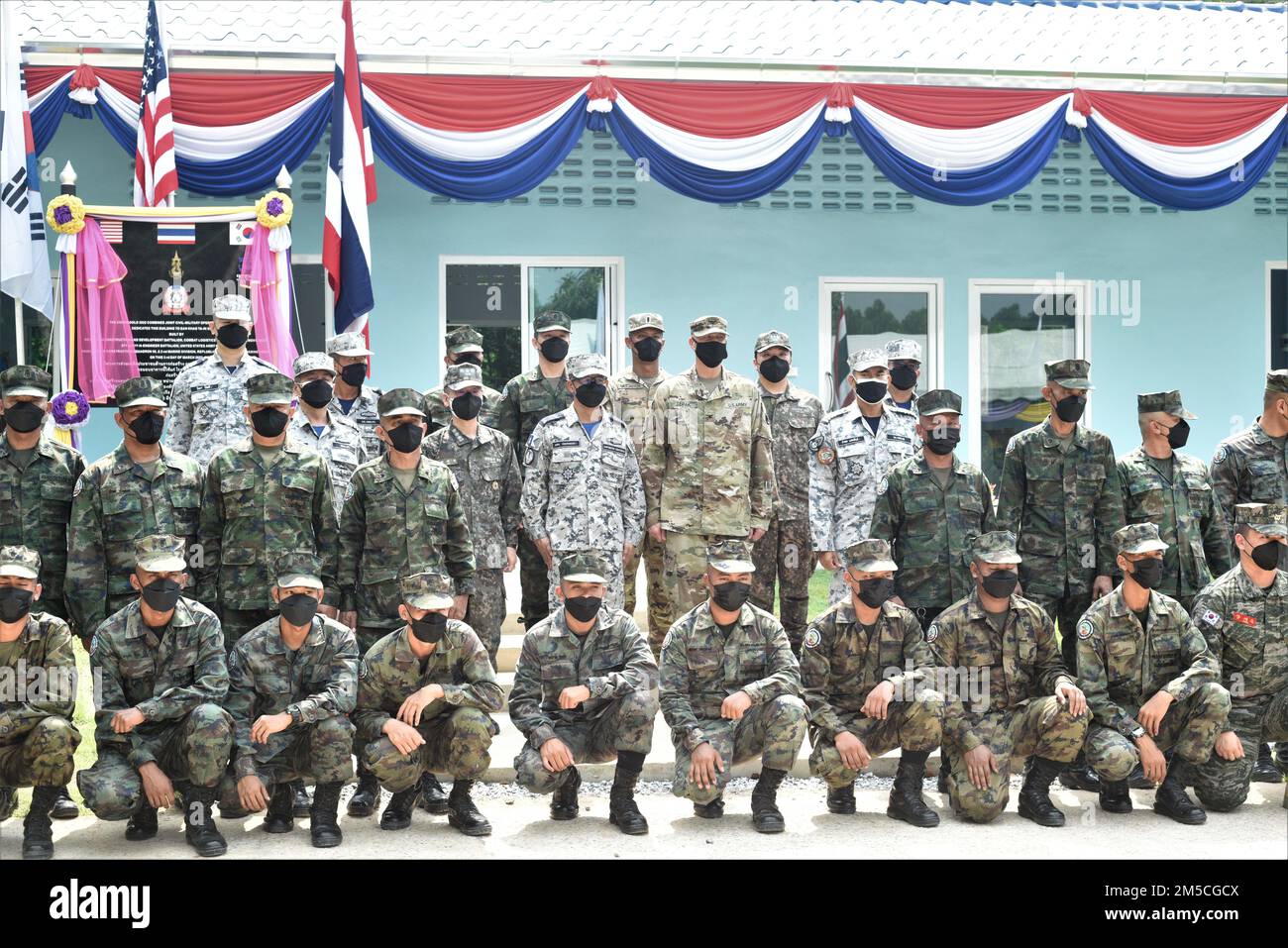 Leaders and soldiers with the combined, Indo-Pacific joint force pose after the cutting the ceremonial ribbon of the newly-built school during the dedication ceremony as part of Cobra Gold 2022 in Rayong, Rayong Province, Kingdom of Thailand, March 2, 2022. CG 22 is the 41st iteration of the international training exercise that supports readiness and emphasizes coordination on civic action, humanitarian assistance, and disaster relief. From Feb. 22 through March 4, 2022, this annual event taking place at various locations throughout the Kingdom of Thailand increases the capability, capacity, a Stock Photo