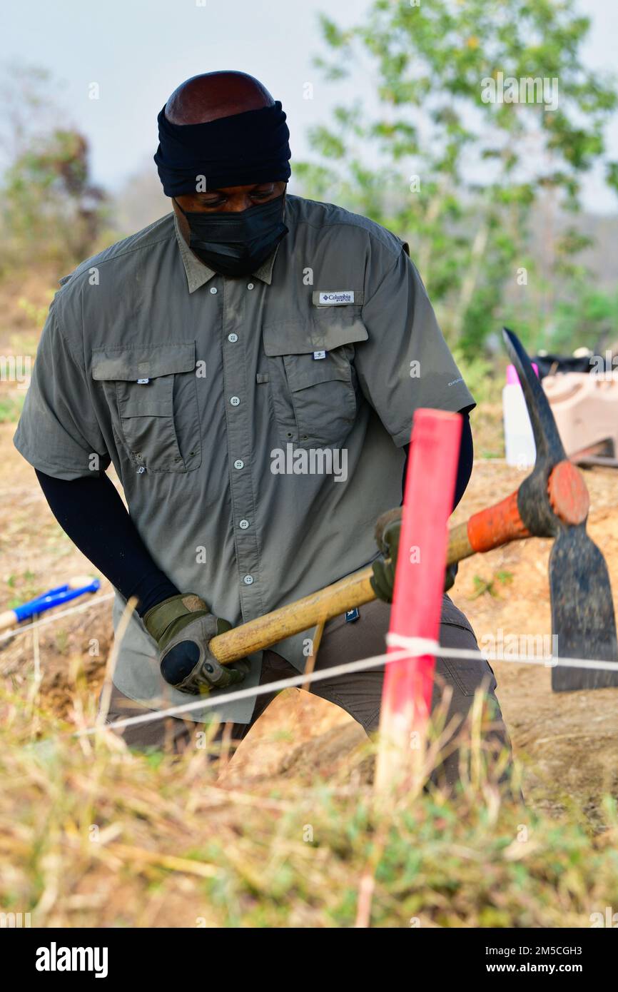Freddie Smith, Defense POW/MIA Accounting Agency (DPAA) life support investigator, swings a pick-axe during a recovery operation in Lampang province, Kingdom of Thailand, March 1, 2022. This mission is DPAA’s effort to locate a missing service member from a crash site during World War II. DPAA’s mission is to achieve the fullest possible accounting for missing and unaccounted-for U.S. personnel to their families and the nation (U.S. Army video by Sgt. 1st Class Michael O'Neal) Stock Photo