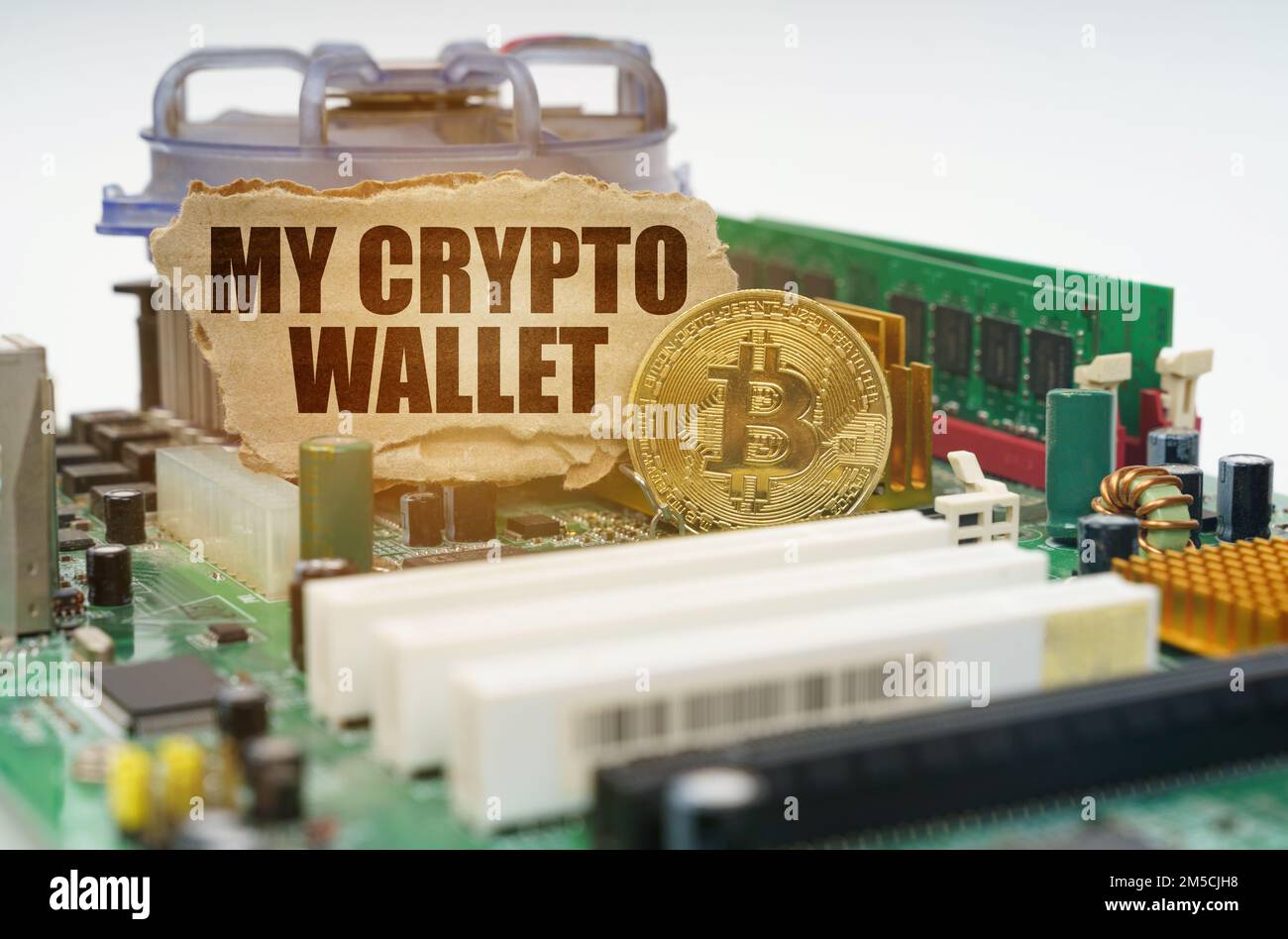 Crypto - business concept. On the motherboard lies a bitcoin coin and a cardboard sign with the inscription - My crypto wallet Stock Photo