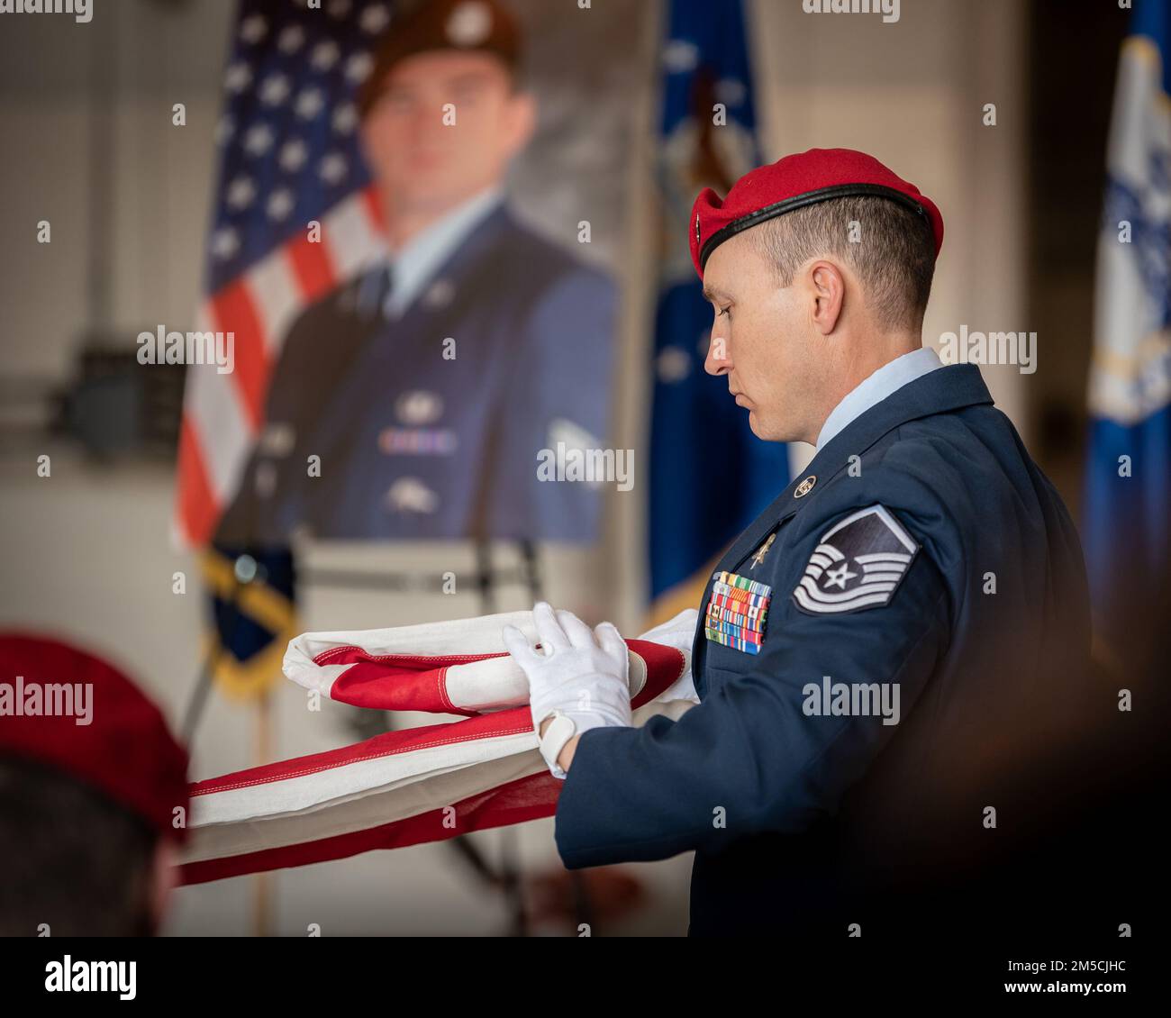 Members of the 123rd Special Tactics Squadron honor a fallen Airman with a flag-folding ceremony during a memorial service at the Kentucky Air National Guard Base in Louisville, Ky., March 1, 2022. The Airman, who died Feb. 16, was a pararescueman with more than 18 years of service to the U.S. Air Force and Air National Guard. Stock Photo