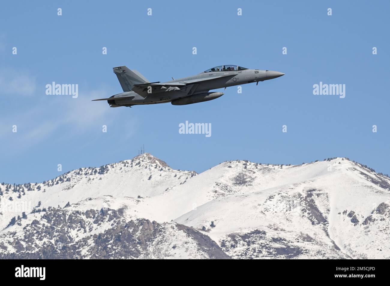 An F/A-18F Super Hornet flies multiple passes at different altitudes over the runway during a series of 5G avionics tests March 1, 2022, at Hill Air Force Base, Utah. A 5G mobile test station was used during the testing as part of demonstration to implement 5G technologies without compromising the safety of military and civilian aircraft. Stock Photo
