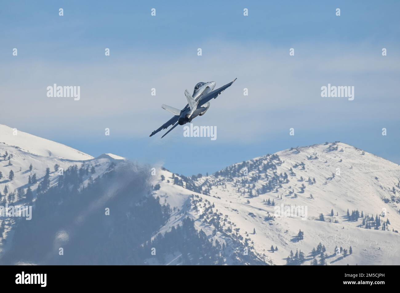 An F/A-18F Super Hornet flies multiple passes at different altitudes over the runway during a series of 5G avionics tests March 1, 2022, at Hill Air Force Base, Utah. A 5G mobile test station was used during the testing as part of demonstration to implement 5G technologies without compromising the safety of military and civilian aircraft. Stock Photo