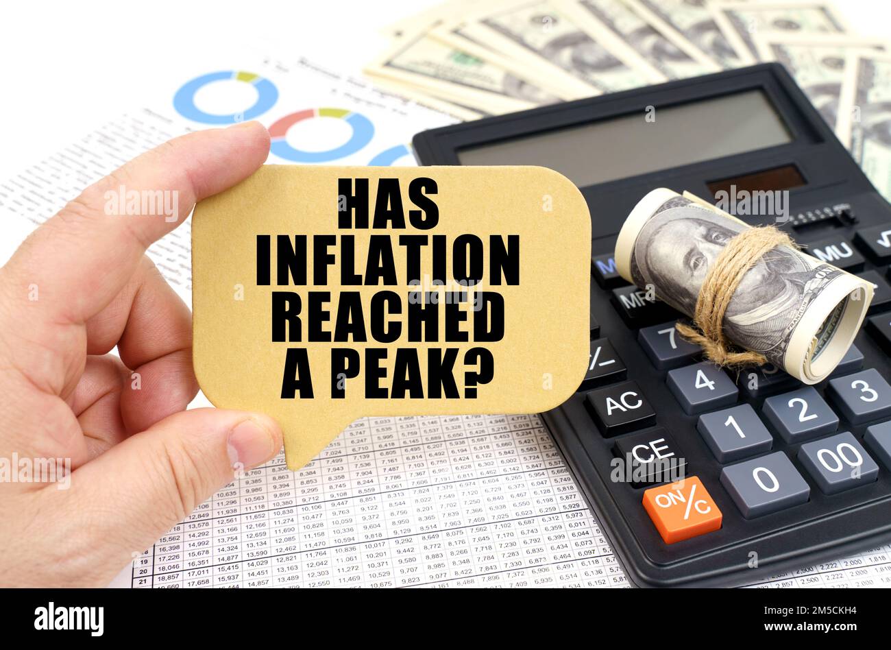 Man Using Inflation Calculator Business concept. Against the background of a calculator, documents and ...