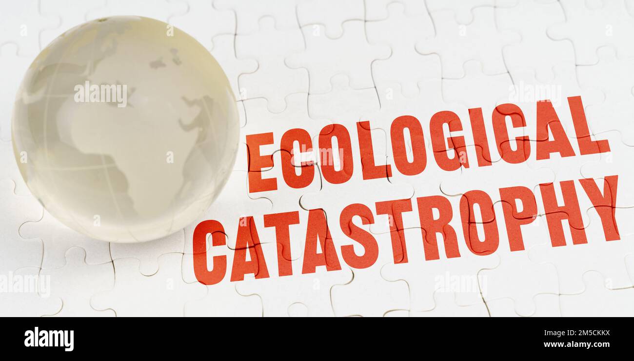 Ecological concept. On white puzzles there is a glass globe and the inscription - Ecological catastrophy Stock Photo