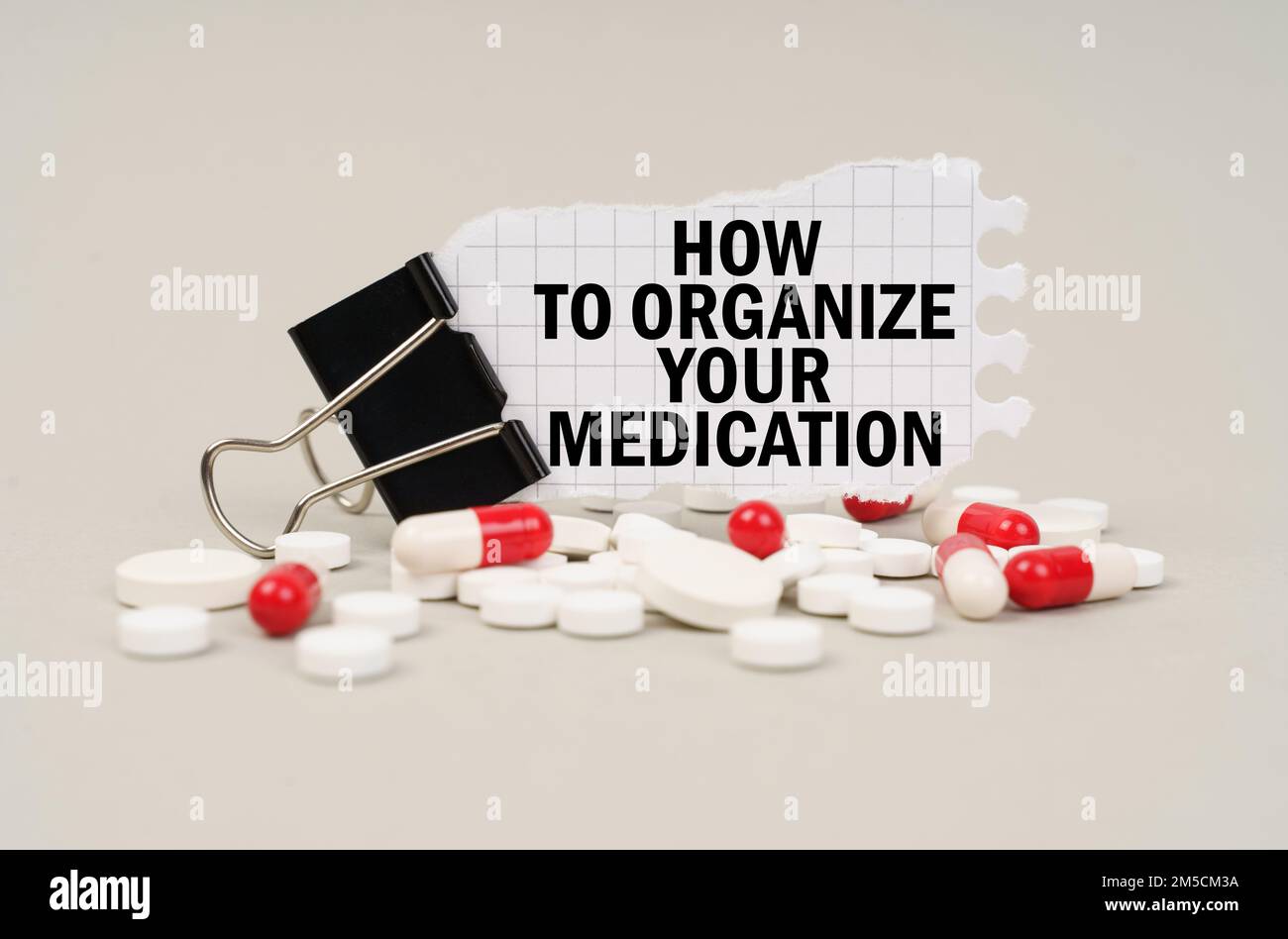 Medical concept. Among the tablets and capsules is a clip with paper on