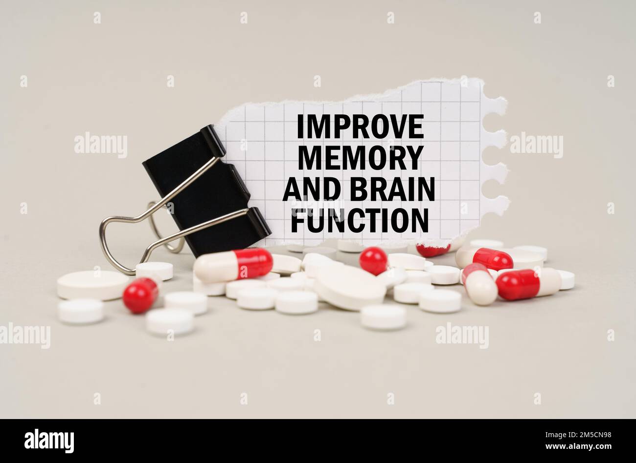 Medical concept. Among the tablets and capsules is a clip with paper on which is written - Improve memory and brain function Stock Photo