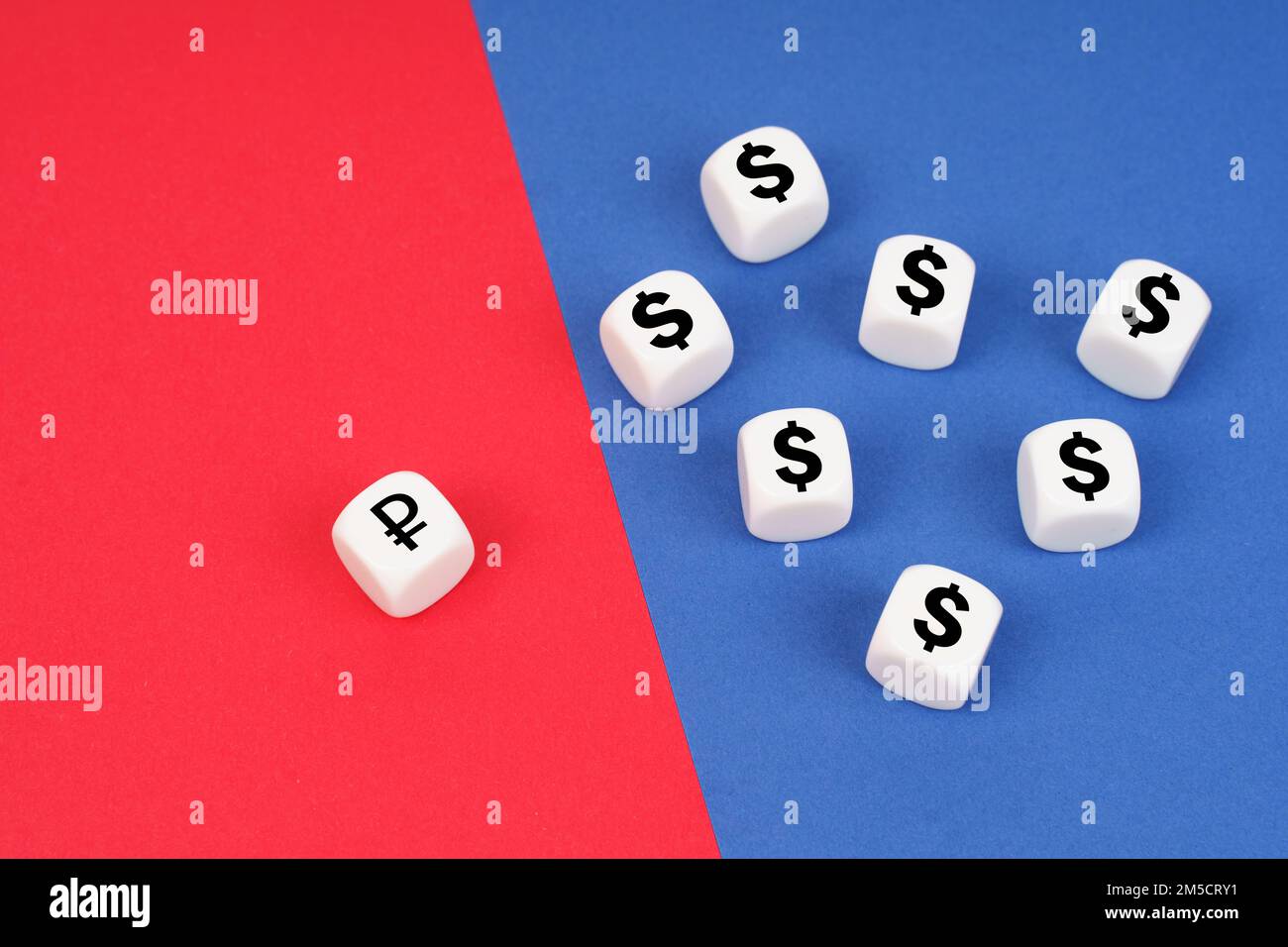Business concept. On a red background, one cube with a ruble symbol, on a blue one, cubes with a dollar symbol. Stock Photo