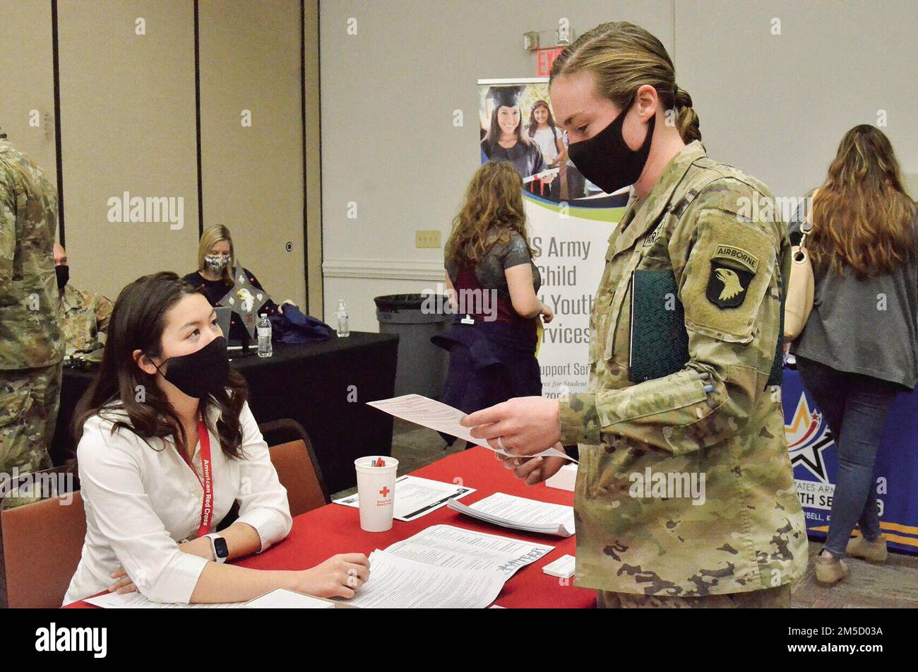 First Lieutenant Caneel Cooper, 2nd Squadron, 17th Cavalry Regiment, 101st Combat Aviation Brigade, 101st Airborne Division (Air Assault), talks to American Red Cross volunteer Serena Vess about the organization’s services March 2 during a deployment readiness at Army Community Service. Stock Photo