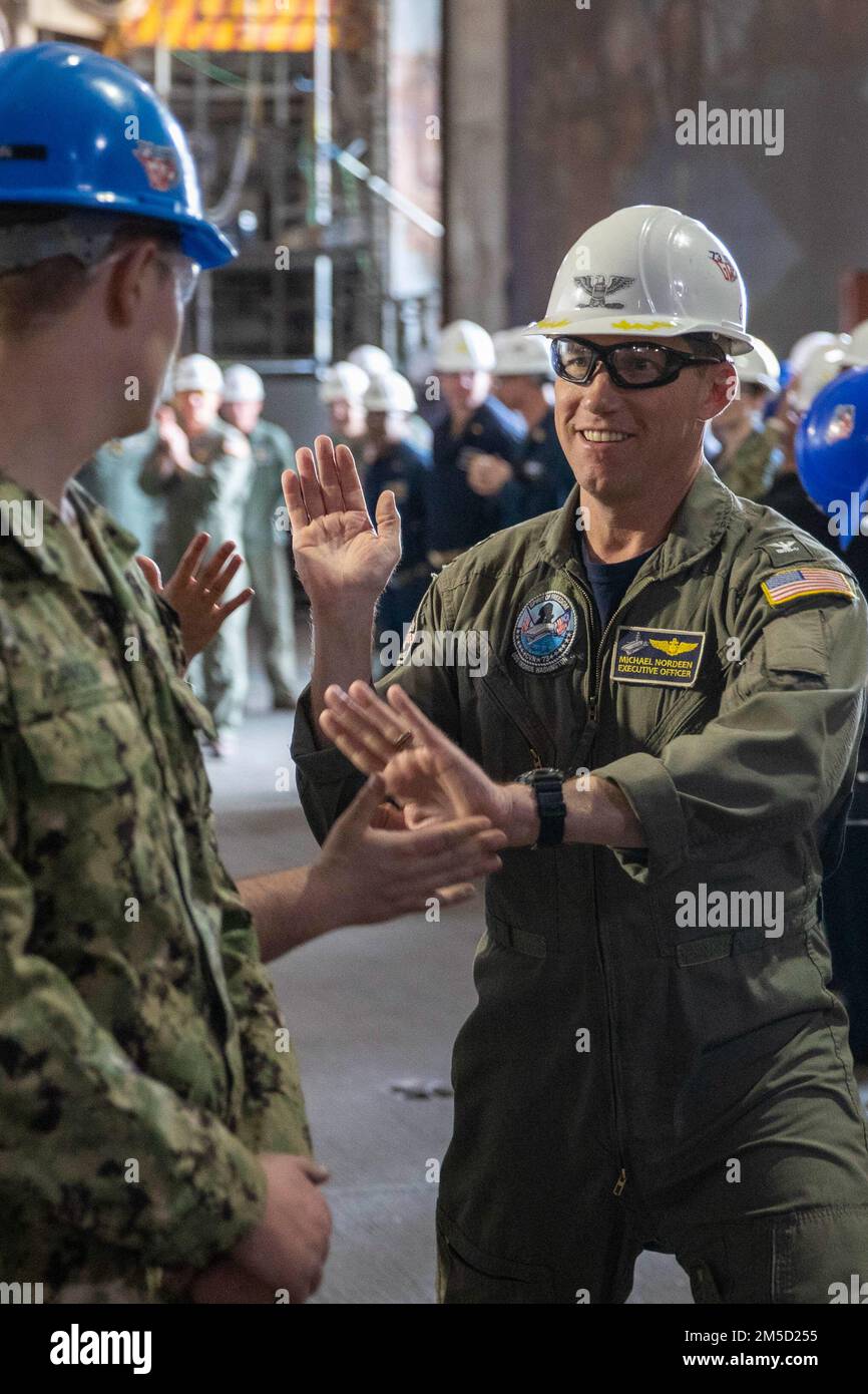 NEWPORT NEWS, Va. (March 3, 2022) – Capt. Michael D. Nordeen, from Necedah, Wisconsin, outgoing executive officer, aboard the Nimitz-class aircraft carrier USS George Washington (CVN 73), departs the ship during his bong off ceremony. George Washington is undergoing refueling complex overhaul (RCOH) at Newport News Shipyard. RCOH is a multi-year project performed only once during a carrier’s 50-year service life that includes refueling the ship’s two nuclear reactors, as well as significant repairs, upgrades, and modernization. Stock Photo