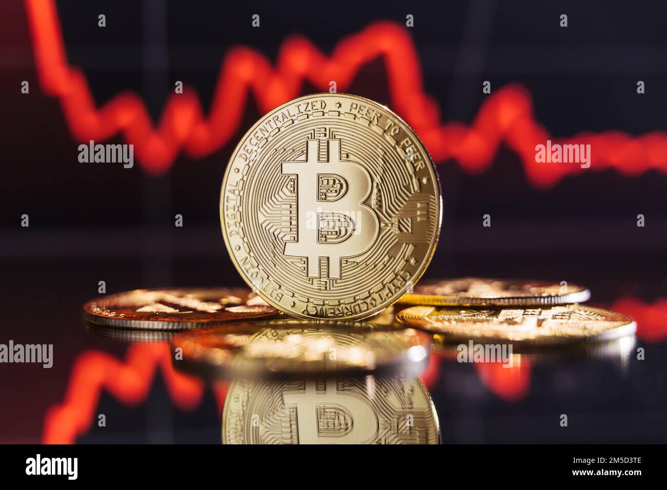 Global recession. Financial crisis. Image of golden bitcoin rising among piles of other crypto coins on digital background of chart with sole thick red line representing crash of crypto trading market Stock Photo
