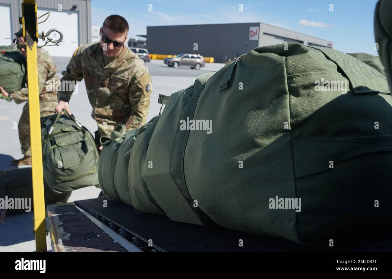 Soldiers from 1st Battalion, 109th Infantry Regiment, 2nd Infantry Brigade Combat Team, 28th Infantry Division, load duffle bags onto the conveyer belt in preparation for depart Harrisburg International Airport on March 4, 2022. The Soldiers begin their deployment to support the Multinational Force and Observer mission in the Sinai Stock Photo