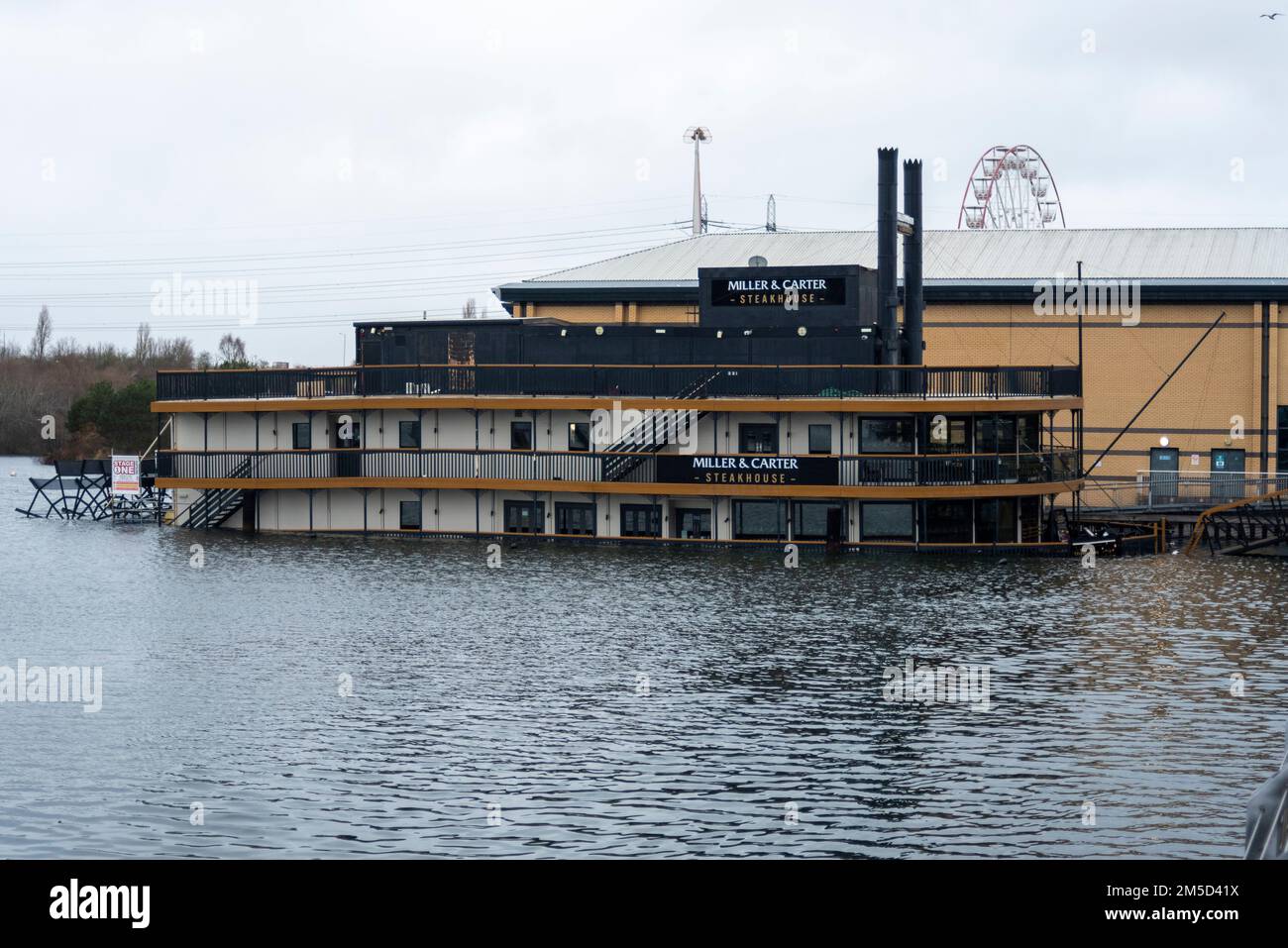 Lakeside Shopping Centre, West Thurrock, Essex, UK. 28th Dec, 2022. A Miller & Carter Steakhouse restaurant paddle boat which began to take on water on the 23rd Dec has fully settled on to the bottom of the lake on the edge of the Lakeside shopping centre. The few staff on board at the time were quickly evacuated and no-one was hurt. Christmas restaurant bookings have all had to be cancelled, including those hoping to eat on Christmas Day Stock Photo