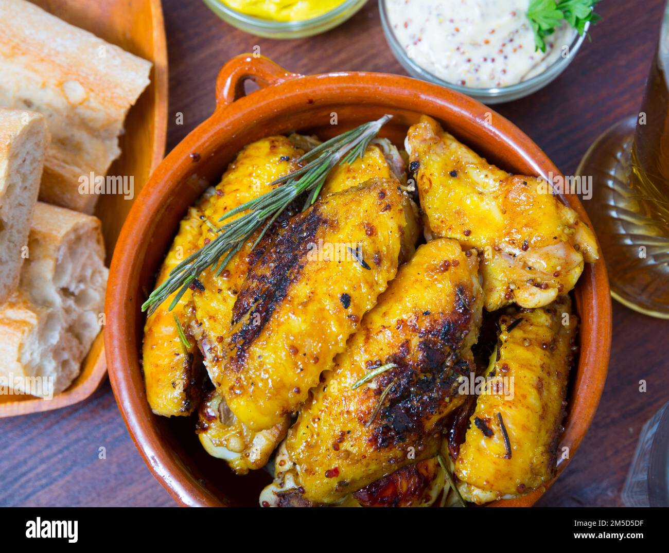 Baked chicken wings in clay pot Stock Photo - Alamy