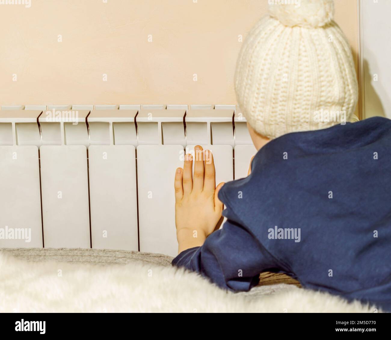 One Toddler Boy Holding Heating Thermostat On Radiator Early Child  Devlopment And Heating Costs Crisis Concept Stock Photo - Download Image  Now - iStock