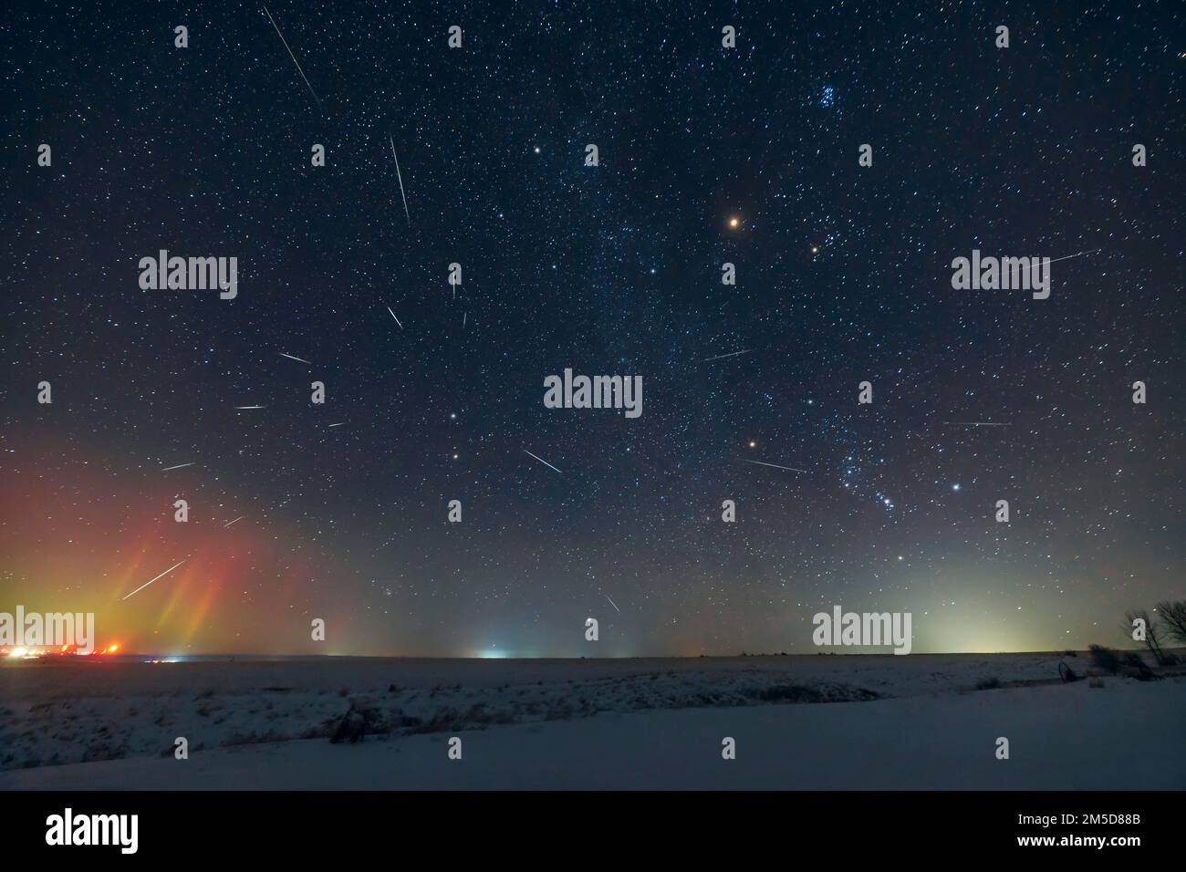 The Geminid meteor shower of 2022, showing the radiant point in Gemini at left, above the stars Castor and Pollux. Orion is at lower right. Mars in Ta Stock Photo