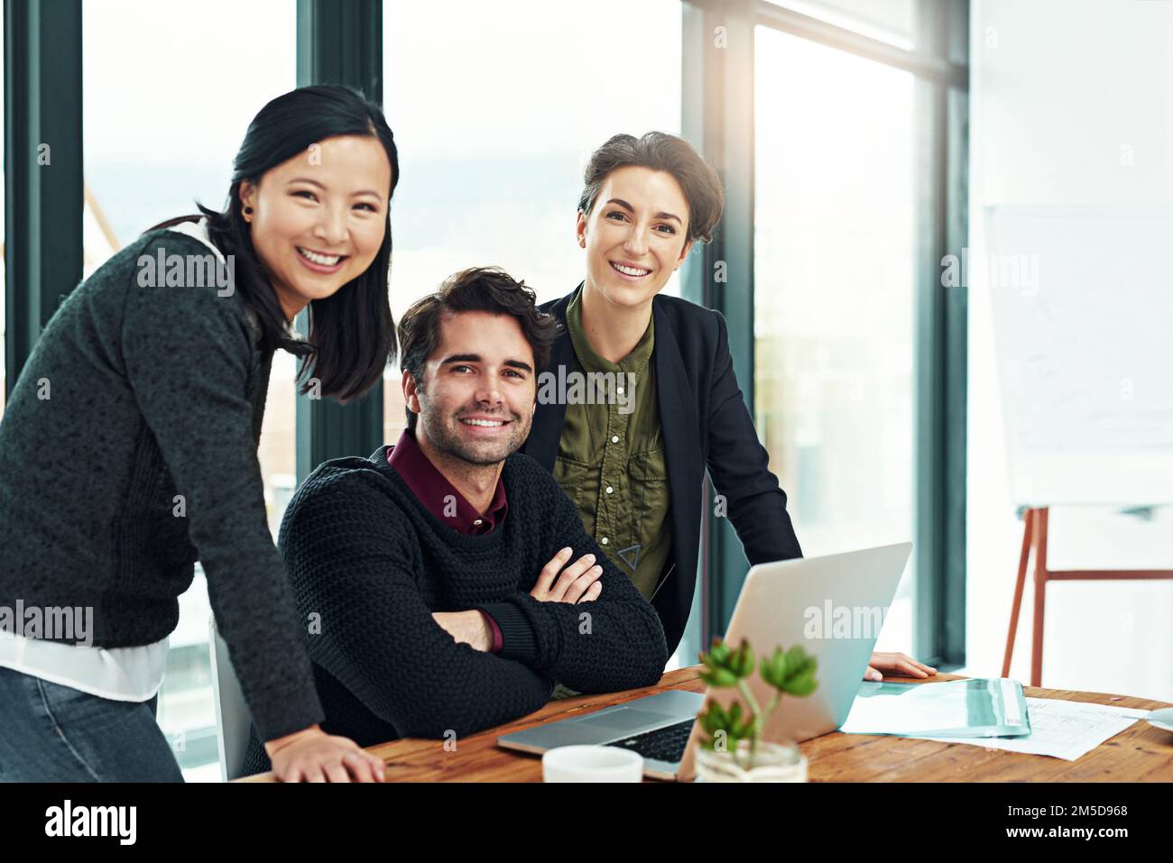 Together were a force to be reckoned with. Cropped portrait of a team of businesspeople discussing work at a desk in their office. Stock Photo
