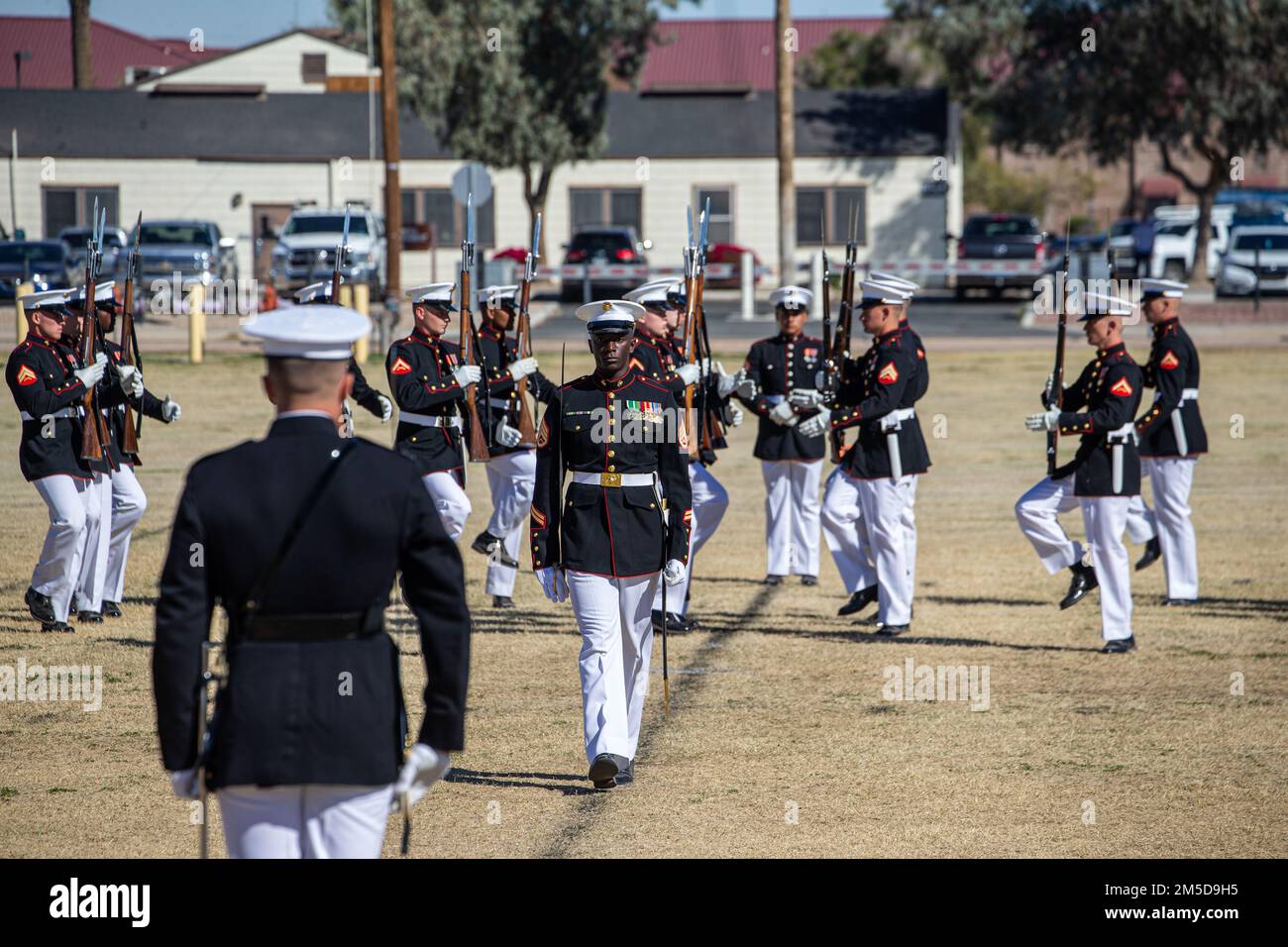 Staff Sgt. Henry Truzy III, platoon sergeant, Silent Drill Platoon, marches onto the field during a Battle Color Ceremony at Marine Corps Air Station Yuma, Ariz., March 3, 2022. This performance was the culmination of multiple weeks of training. Stock Photo
