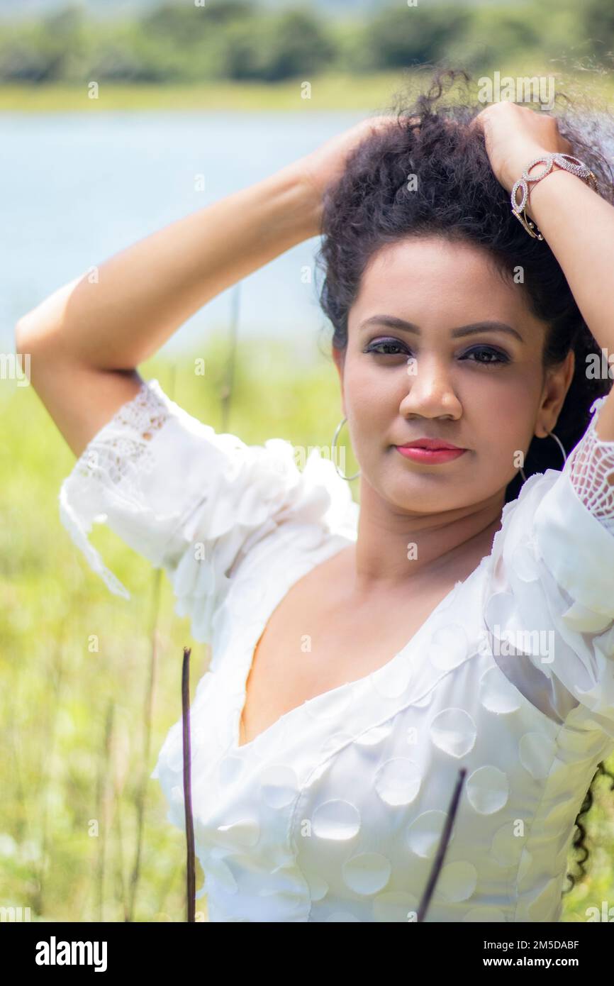 A portrait of attractive young woman posing in the field Stock Photo ...