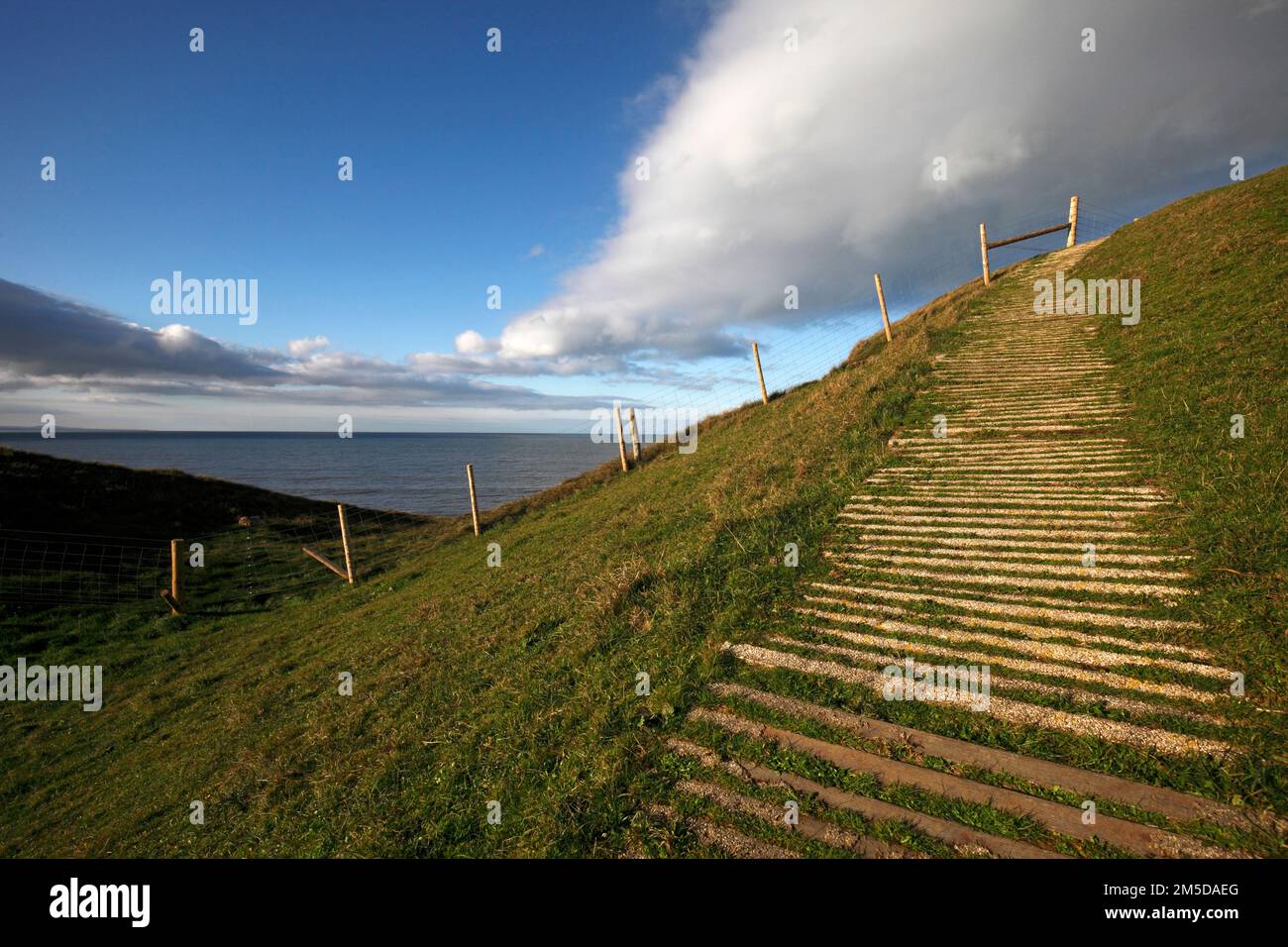 The coastal path climbing to Dinas Dinlle Iron Age hillfort. South of