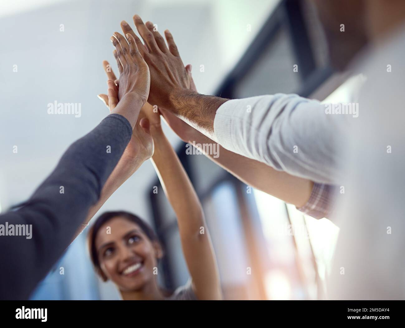 Awesome things are achieved with teamwork. a group of colleagues celebrating an achievement with a high five. Stock Photo