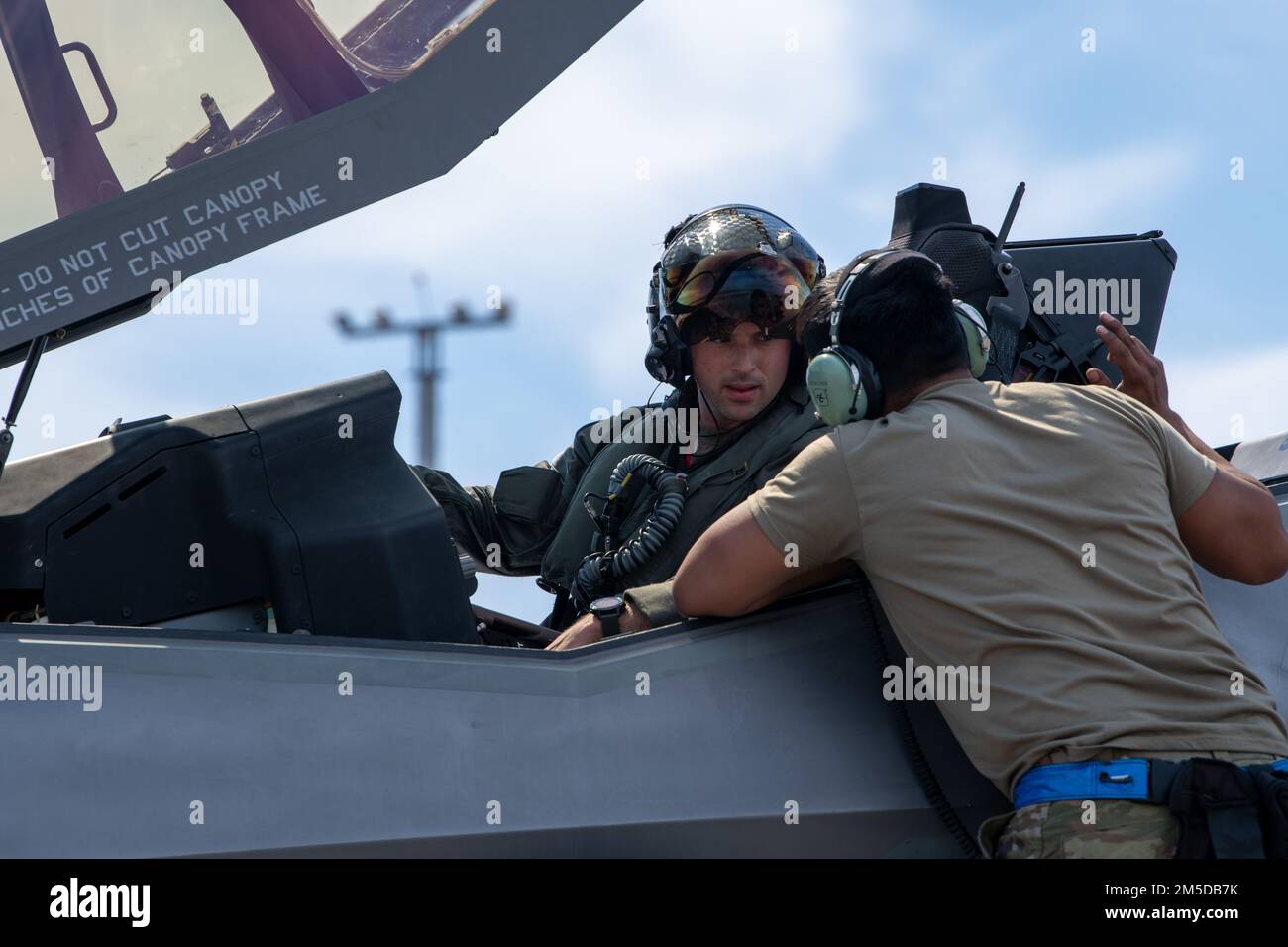 U.S. Air Force Capt. Jack “Shotgun” Miller, 62nd Fighter Squadron F-35A instructor pilot, speaks to Senior Airman Abran Mondragon, 56th Aircraft Maintenance Squadron avionics systems technician, both assigned to Luke AFB, Arizona, prior to a flight at Tyndall AFB, Florida, March 3, 2022. The 62nd FS spent approximately two weeks training out of Tyndall to complete part of their student pilot basic course syllabus. Stock Photo