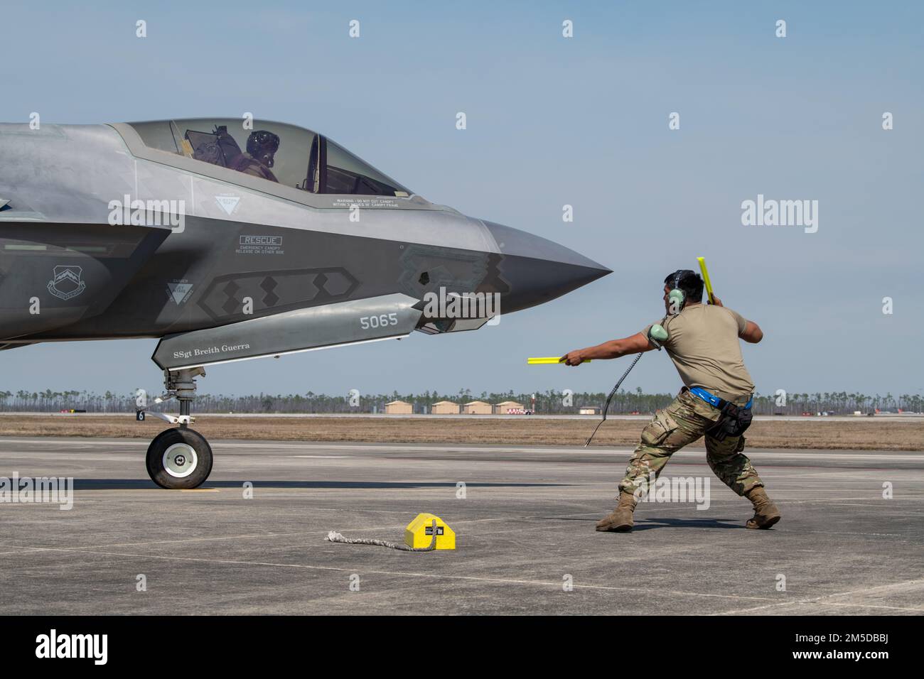 U.S. Air Force Senior Airman Abran Mondragon, 56th Aircraft Maintenance Squadron avionics systems technician, marshals Capt. Jack “Shotgun” Miller, 62nd Fighter Squadron F-35A instructor pilot, both assigned to Luke Air Force Base, Arizona, at Tyndall AFB, Florida, March 3, 2022. The 62nd FS spent approximately two weeks training out of Tyndall to complete part of their student pilot basic course syllabus. Stock Photo