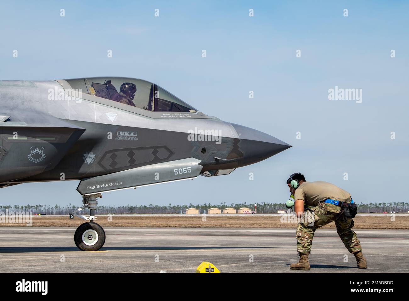 U.S. Air Force Senior Airman Abran Mondragon, 56th Aircraft Maintenance Squadron avionics systems technician, marshals Capt. Jack “Shotgun” Miller, 62nd Fighter Squadron F-35A instructor pilot, both assigned to Luke Air Force Base, Arizona, at Tyndall AFB, Florida, March 3, 2022. The 62nd FS spent approximately two weeks training out of Tyndall to complete part of their student pilot basic course syllabus. Stock Photo