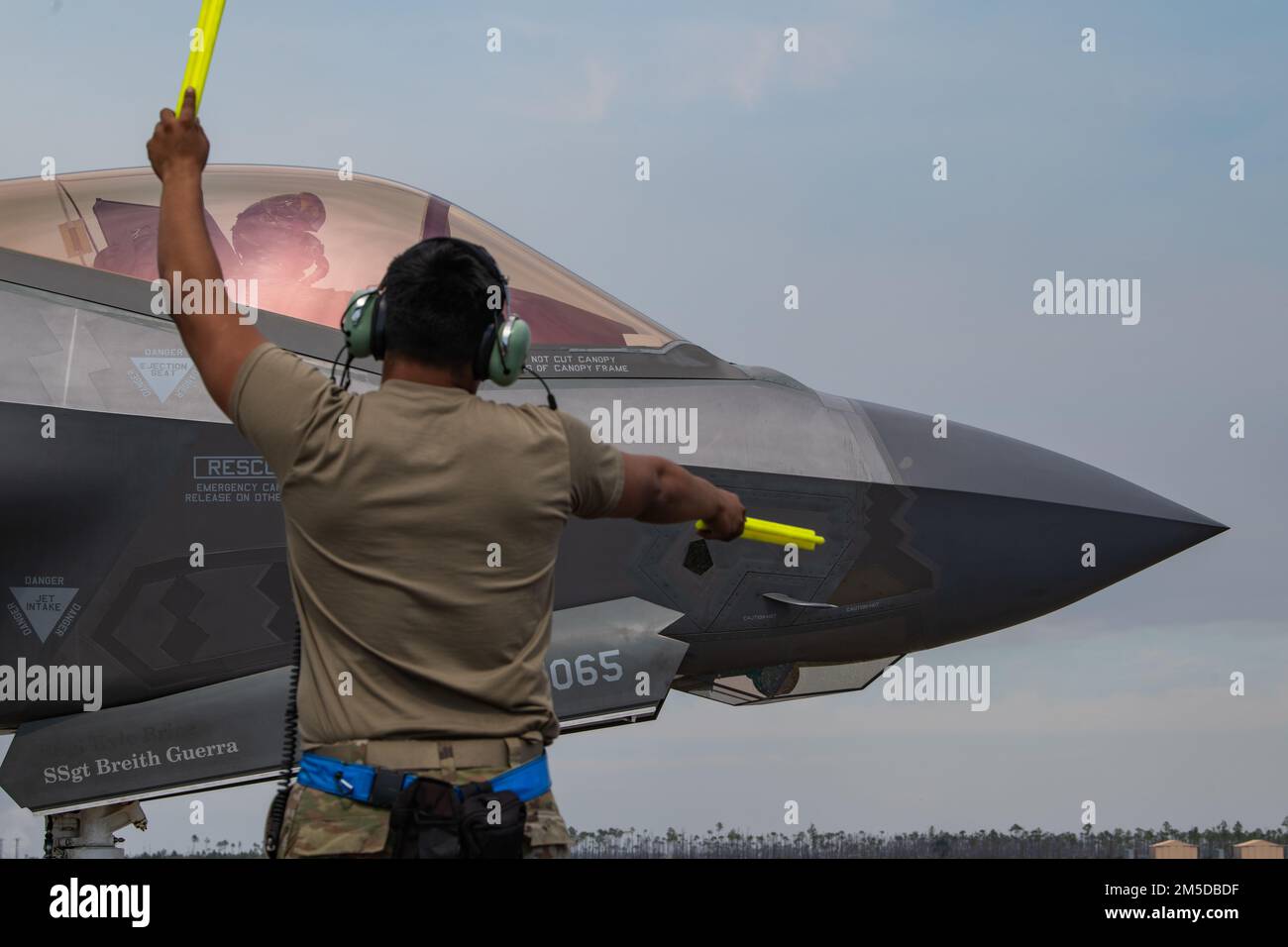 U.S. Air Force Senior Airman Abran Mondragon, 56th Aircraft Maintenance Squadron avionics systems technician, marshals Capt. Jack “Shotgun” Miller, 62nd Fighter Squadron F-35A instructor pilot, both assigned to Luke Air Force Base, Arizona, at Tyndall AFB, Florida, March 3, 2022. The 62nd FS spent approximately two weeks training out of Tyndall to complete part of their student pilot basic course syllabus. Stock Photo