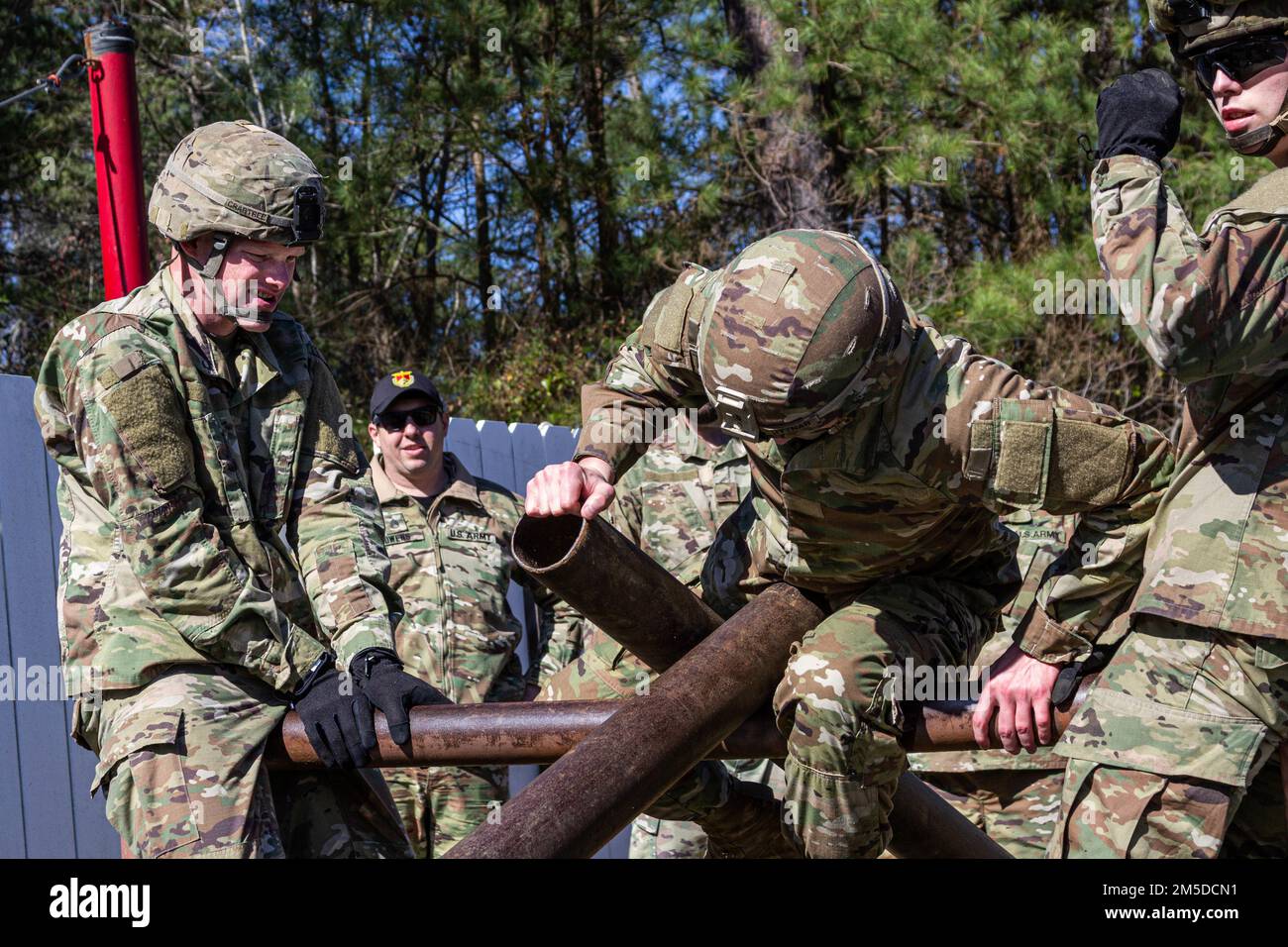 U.S. Army Soldiers attending the U.S. Army Aviation Center of Excellence Noncommissioned Officer Academy - Eustis Advanced Leaders Course navigate the Leaders Reaction Course March 4, 2022 here at Fort Eustis, Virginia. The LRC is a team building obstacle course designed to train skills in leadership, operational planning, time management and self-devlopment. Stock Photo