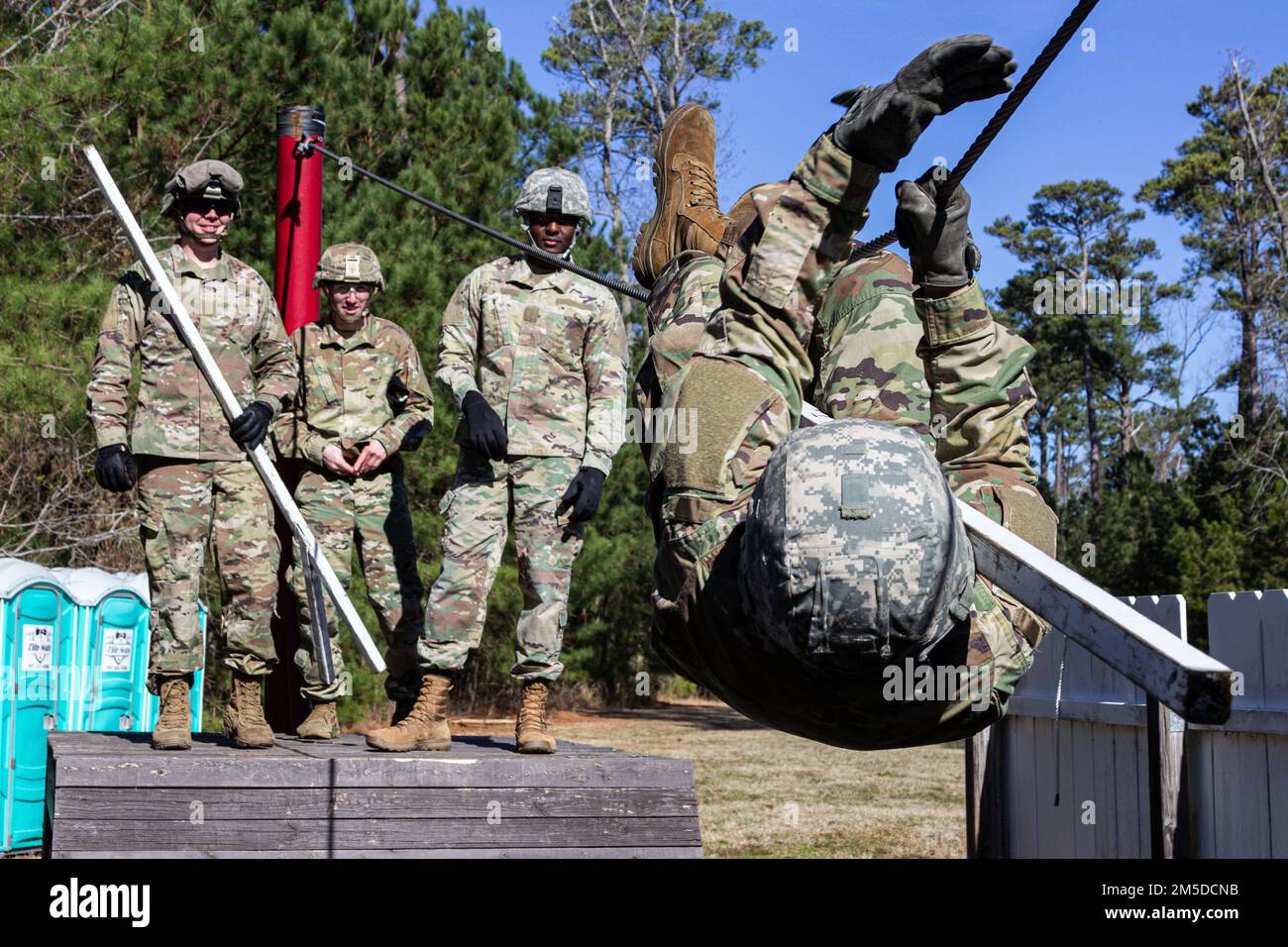 U.S. Army Soldiers attending the U.S. Army Aviation Center of Excellence Noncommissioned Officer Academy - Eustis Advanced Leaders Course navigate the Leaders Reaction Course March 4, 2022 here at Fort Eustis, Virginia. Stock Photo