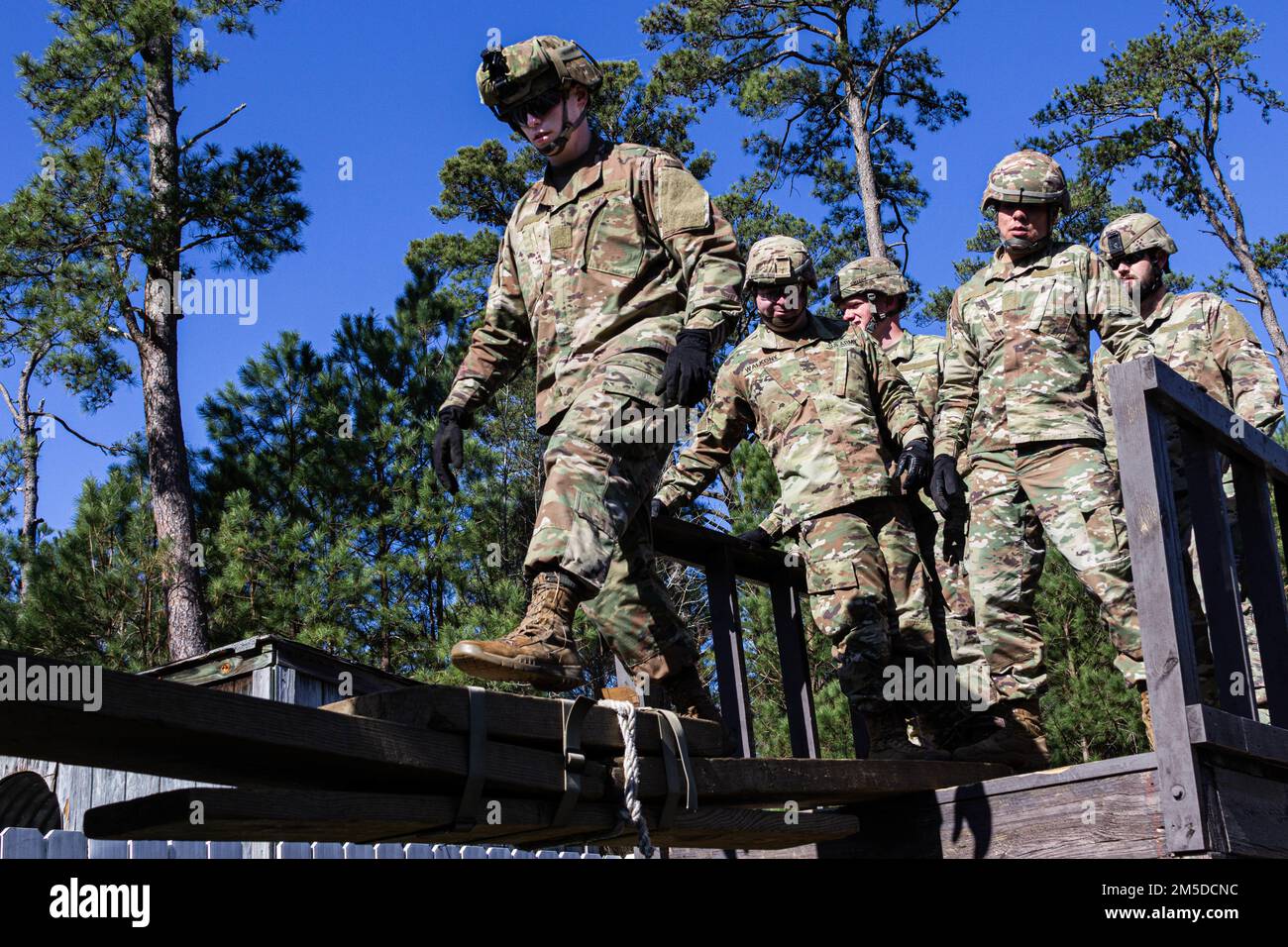 U.S. Army Soldiers attending the U.S. Army Aviation Center of Excellence Noncommissioned Officer Academy - Eustis Advanced Leaders Course navigate the Leaders Reaction Course March 4, 2022 here at Fort Eustis, Virginia. The LRC is a team building obstacle course designed to train skills in leadership, operational planning, time management and self-devlopment. Stock Photo