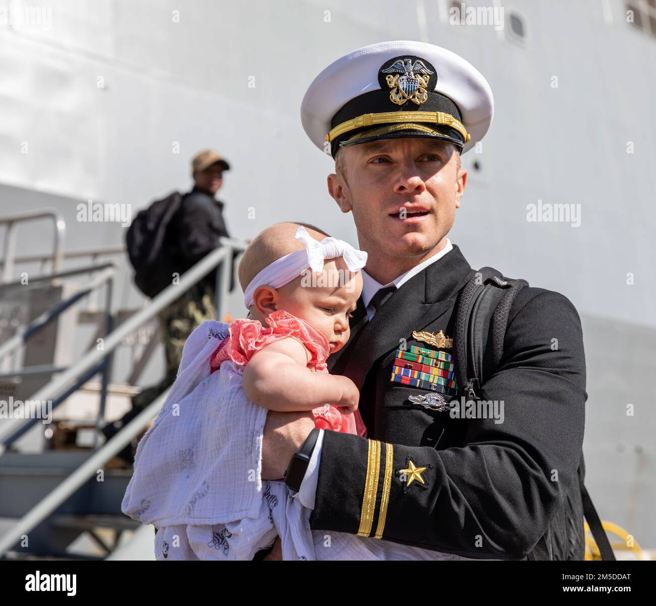 220304-N-LR905-2179  SAN DIEGO (March 4, 2022) – Lt. j.g. Mather, currently assigned to amphibious transport dock ship USS Portland (LPD 27), embraces his child for the first time March 4. Portland, a part of the Essex Amphibious Ready Group, returned to Naval Base San Diego March 4 after a deployment to U.S. 3rd, 5th, and 7th Fleets in support of regional stability and a free and open Indo-Pacific. Stock Photo