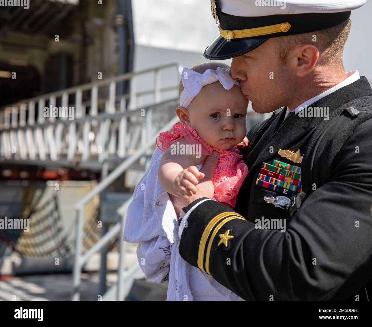 220304-N-LR905-2175  SAN DIEGO (March 4, 2022) – Lt. j.g. Mather, currently assigned to amphibious transport dock ship USS Portland (LPD 27), embraces his child for the first time March 4. Portland, a part of the Essex Amphibious Ready Group, returned to Naval Base San Diego March 4 after a deployment to U.S. 3rd, 5th, and 7th Fleets in support of regional stability and a free and open Indo-Pacific. Stock Photo