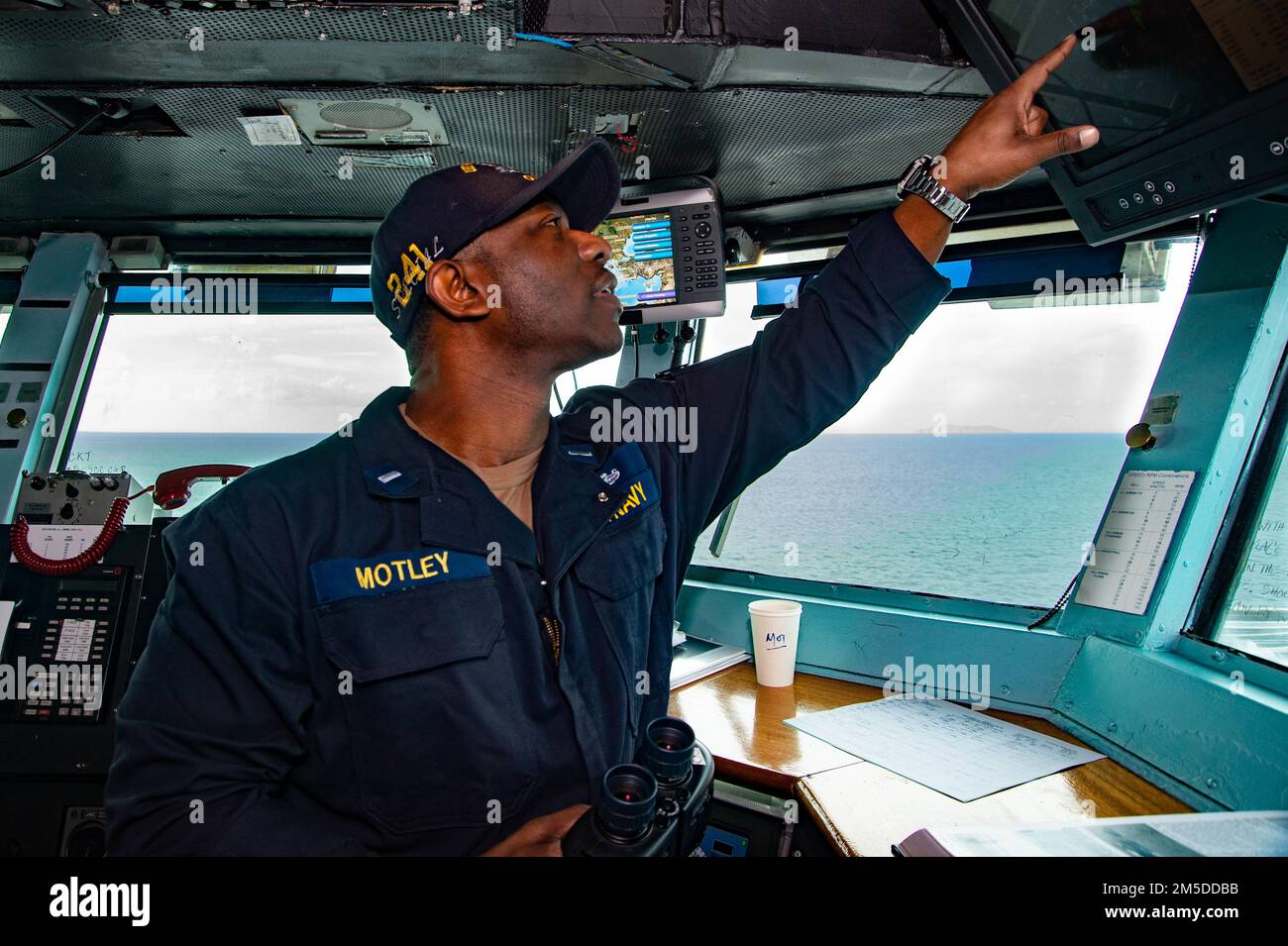 220304-N-TO573-1099 NORTH AEGEAN SEA (Mar. 4, 2022) Lt. j.g. Dennis Motley, from Flint, Michigan, confirms coordinates on the bridge of the Nimitz-class aircraft carrier USS Harry S. Truman (CVN 75), Mar. 4, 2022. The Harry S. Truman Carrier Strike Group is on a scheduled deployment in the U.S. Sixth Fleet area of operations in support of U.S., allied and partner interests in Europe and Africa. Stock Photo