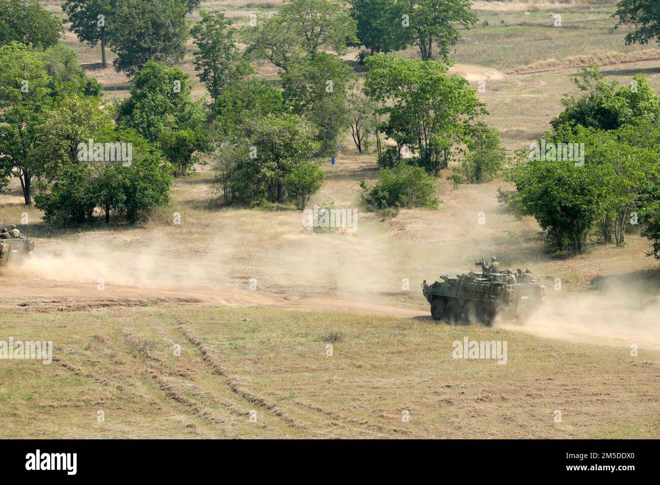Royal Thai Army soldiers drive out in M1129 Stryker mortar system vehicles during a combined arms live fire exercise as part of Cobra Gold 2022, in the Lopburi Province of the Kingdom of Thailand, Mar. 4, 2022. CG 22 is the 41st iteration of the international training exercise that supports readiness and emphasizes coordination on civic action, humanitarian assistance, and disaster relief. From Feb. 22 through March 4, 2022, this annual event taking place at various locations throughout the Kingdom of Thailand increases the capability, capacity, and interoperability of partnered nations while Stock Photo