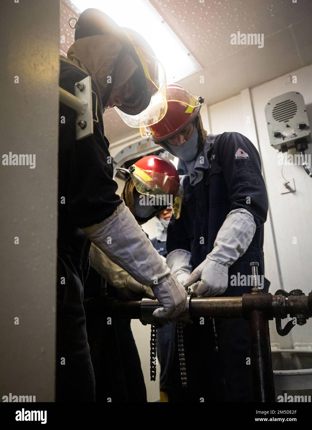 220304-N-LI768-1010  PHILIPPINE SEA (March 4, 2022) – Sailors apply a jubilee patch to a ruptured pipe during damage control training aboard the Independence-variant littoral combat ship USS Tulsa (LCS 16). Tulsa, part of Destroyer Squadron (DESRON) 7, is on a rotational deployment, operating in the U.S. 7th Fleet area of operations to enhance interoperability with partners and serve as a ready-response force in support of a free and open Indo-Pacific region. Stock Photo