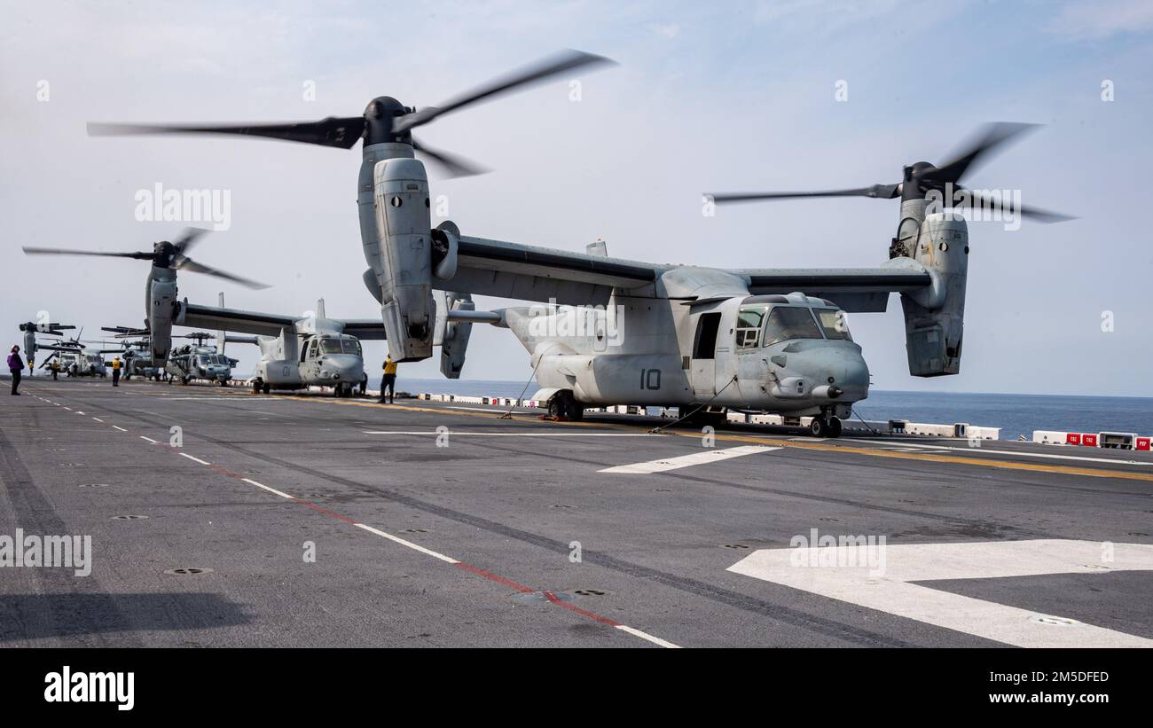 PHILIPPINE SEA (March. 4, 2022) MV-22B Osprey aircraft from the 31st Marine Expeditionary Unit (MEU) prepare to take off from the flight deck of the forward-deployed amphibious assault ship USS America (LHA 6). America, lead ship of the America Amphibious Ready Group, along with the 31st MEU, is operating in the U.S. 7th Fleet area of responsibility to enhance interoperability with allies and partners and serve as a ready response force to defend peace and stability in the Indo-Pacific region. Stock Photo