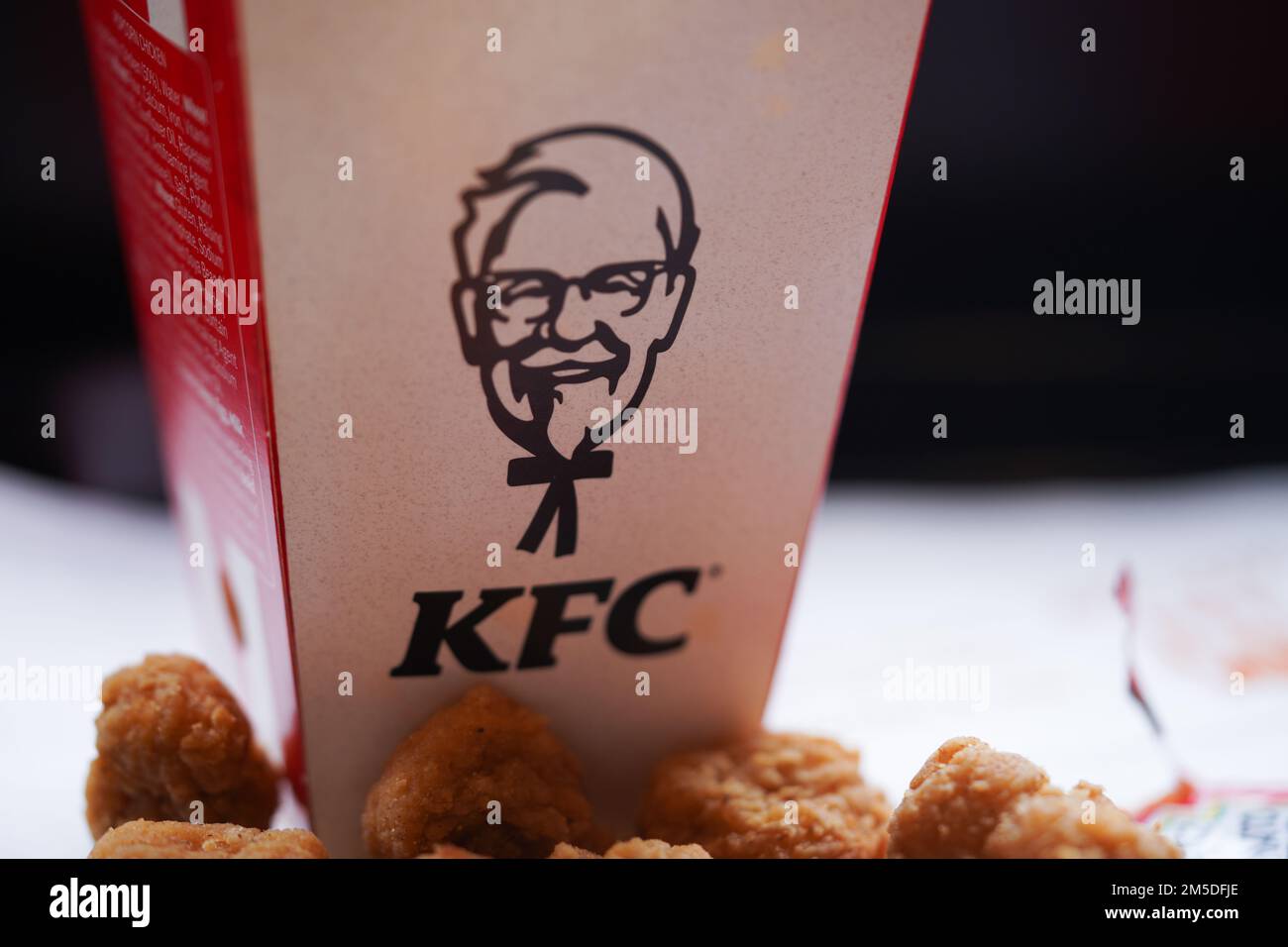 Fried popcorn chicken on the restaurant plate with natural sunlight. KFC restaurant. KFC is a popular fast-food chain known as Kentucky Fried Chicken. Stock Photo