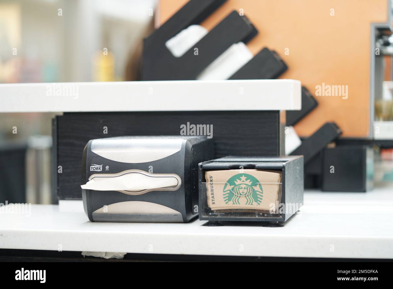 Starbucks coffee place interior in central Reading. Help yourself bar. Starbucks tissue on white table at the service counter for customer convenience Stock Photo