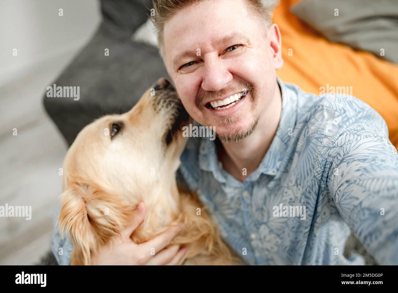 Smiling guy man with golden retriever dog Stock Photo Alamy
