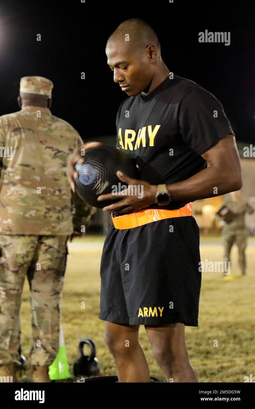 Hawaii Army National Guard (HIARNG) Soldier, Spc. Kevin T. Brown, a mass communication specialist with the 117th Mobile Public Affairs Detachment (MPAD), 103rd Troop Command, prepares to conduct the standing power throw (SPT) during the annual Best Warrior Competition (BWC) Army Combat Fitness Test (ACFT) event at the Regional Training Institute (RTI), Waimanalo, Hawaii, March 4, 2022. The SPT measures upper and lower body explosive power, flexibility and dynamic balance assisting with tasks like a buddy drag, throwing a hand grenade and employing progressive levels of force in man-to-man cont Stock Photo