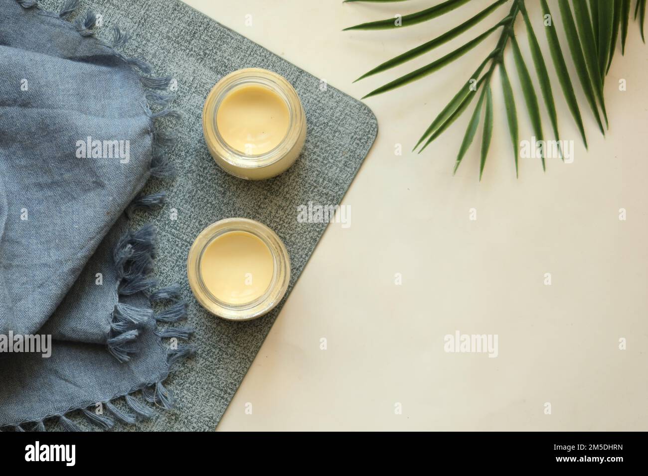 Caramel pudding in a glass jar on table  Stock Photo