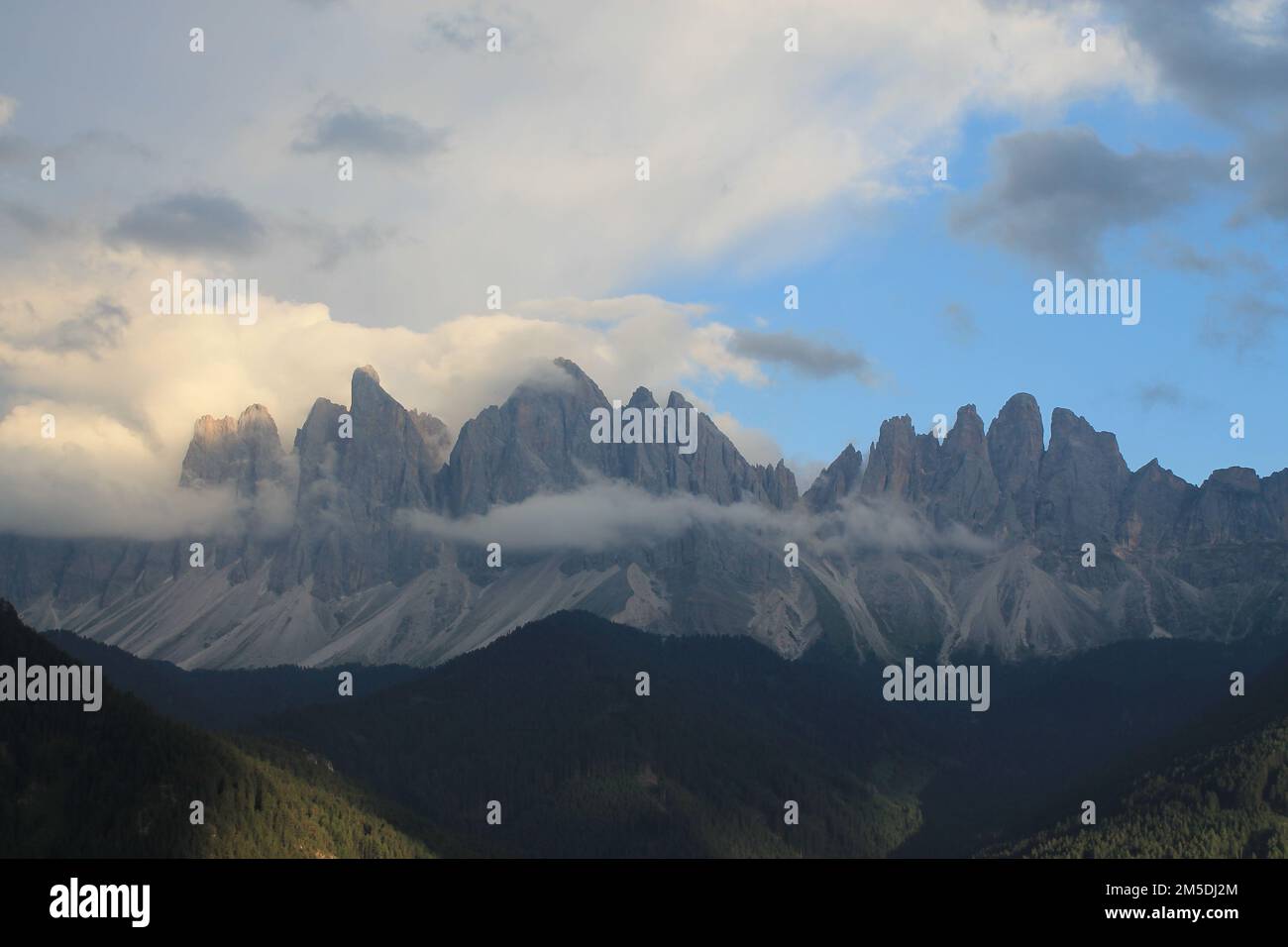 A scenic view of the Dolomites Alps covered with clouds Stock Photo - Alamy