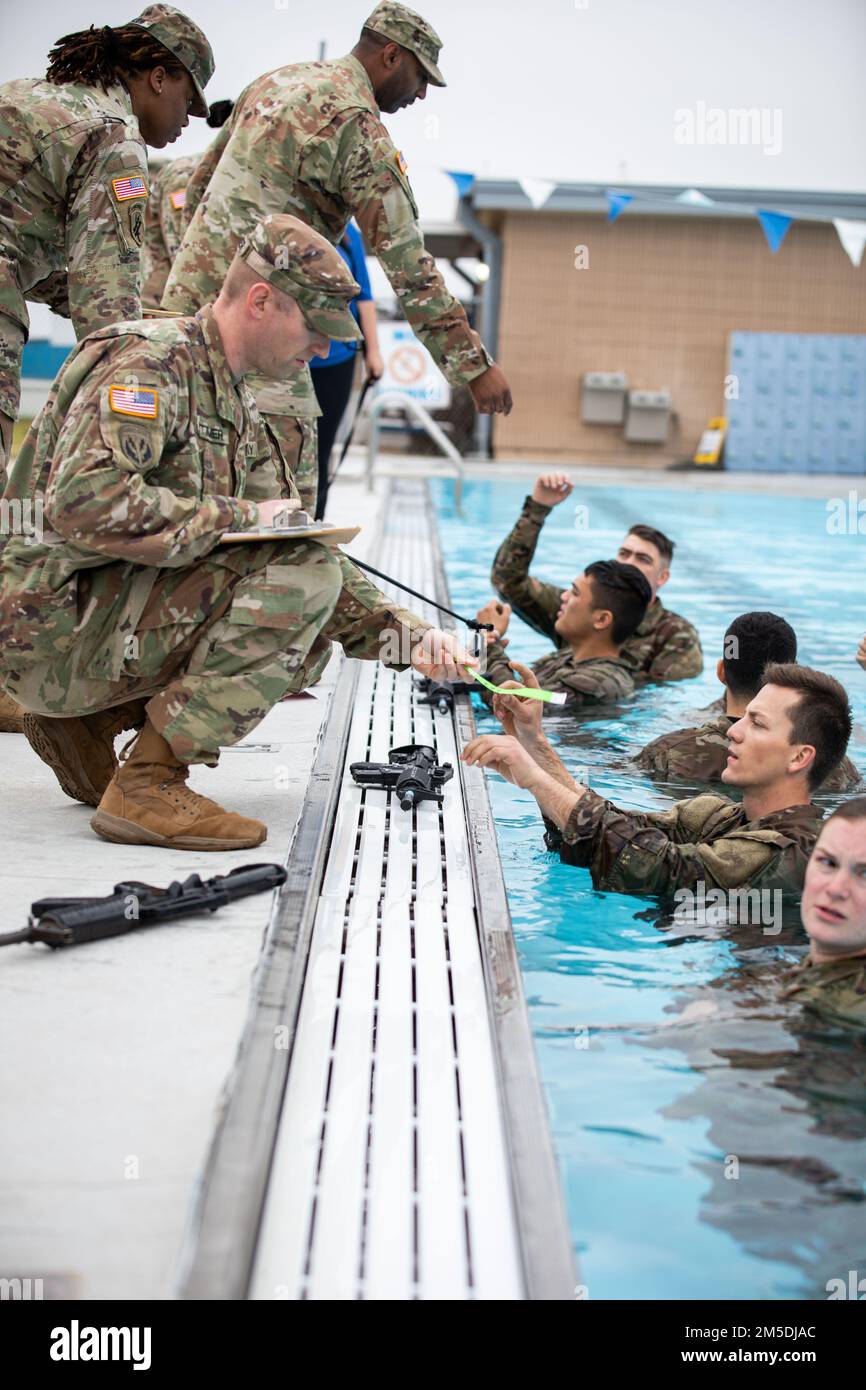 63rd Readiness Division cadre assist Soldiers in the swim event at consortium best warrior competition from March 3 through the 6 at Camp Bullis in San Antonio, Texas. The 2022 consortium BWC consists of a 12-mile ruck march, weapon qualifications, the Army Combat Fitness Test, water survival, obstacle course, land navigation, and urban warfare. This competition was a joint event featuring Soldiers from the 80th Training Command, 807th Medical Command, 76th Operational Response Command, 63rd Readiness Division, 81st RD, 88th RD and the 99th RD. Stock Photo