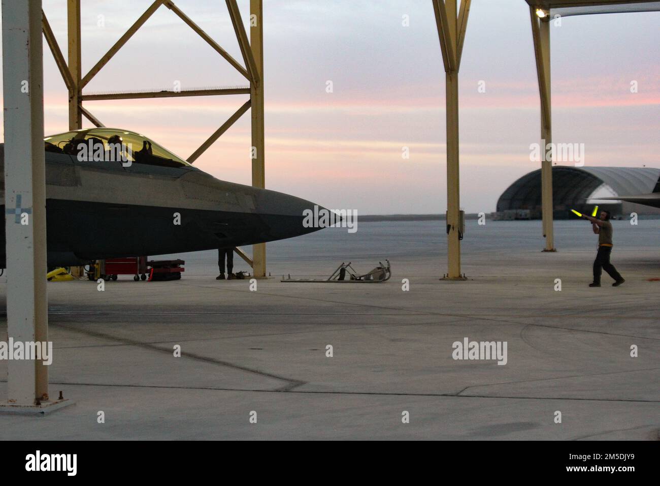 An U.S. Air Force F-22 Raptor prepares for an early evening takeoff at Al  Dhafra Air Base, United Arab Emirates, arch 5, 2022. The F-22s were rapidly  deployed to the base earlier