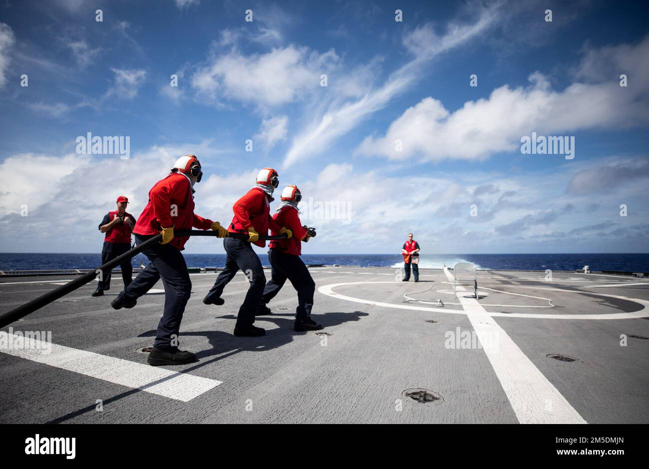 220305-N-LI768-1053  PHILIPPINE SEA (March 5, 2022) – Sailors sidestep while fighting a simulated fire on the flight deck during aviation damage control training aboard the Independence-variant littoral combat ship USS Tulsa (LCS 16). Tulsa, part of Destroyer Squadron (DESRON) 7, is on a rotational deployment, operating in the U.S. 7th Fleet area of operations to enhance interoperability with partners and serve as a ready-response force in support of a free and open Indo-Pacific region. Stock Photo
