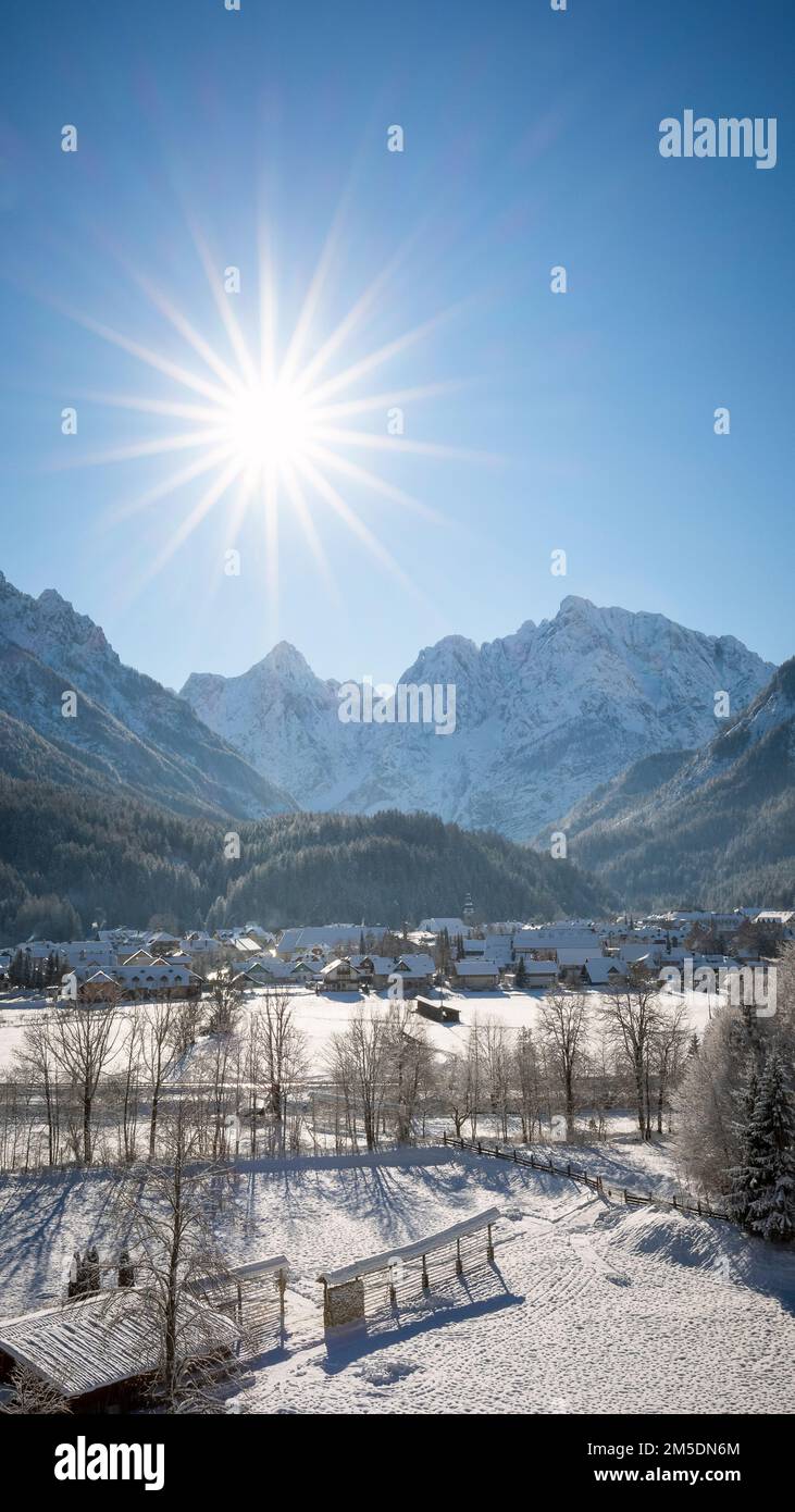 Kranjska Gora in Slovenia covered in snow at winter with Julian Alps and Triglav National Park in the background Stock Photo