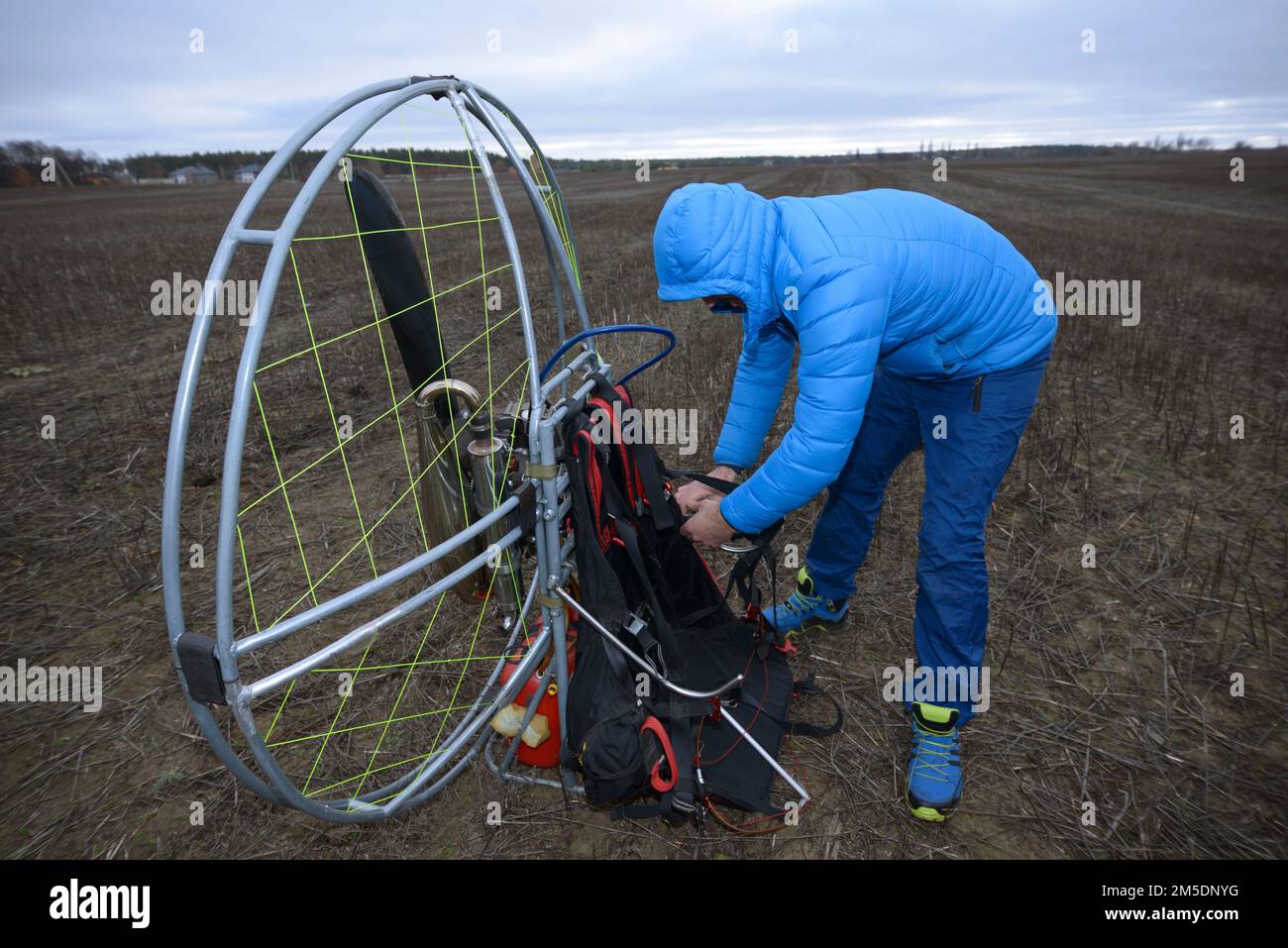 Paramotoring. Man paramotorist preparing paramotor for flight. Kyiv