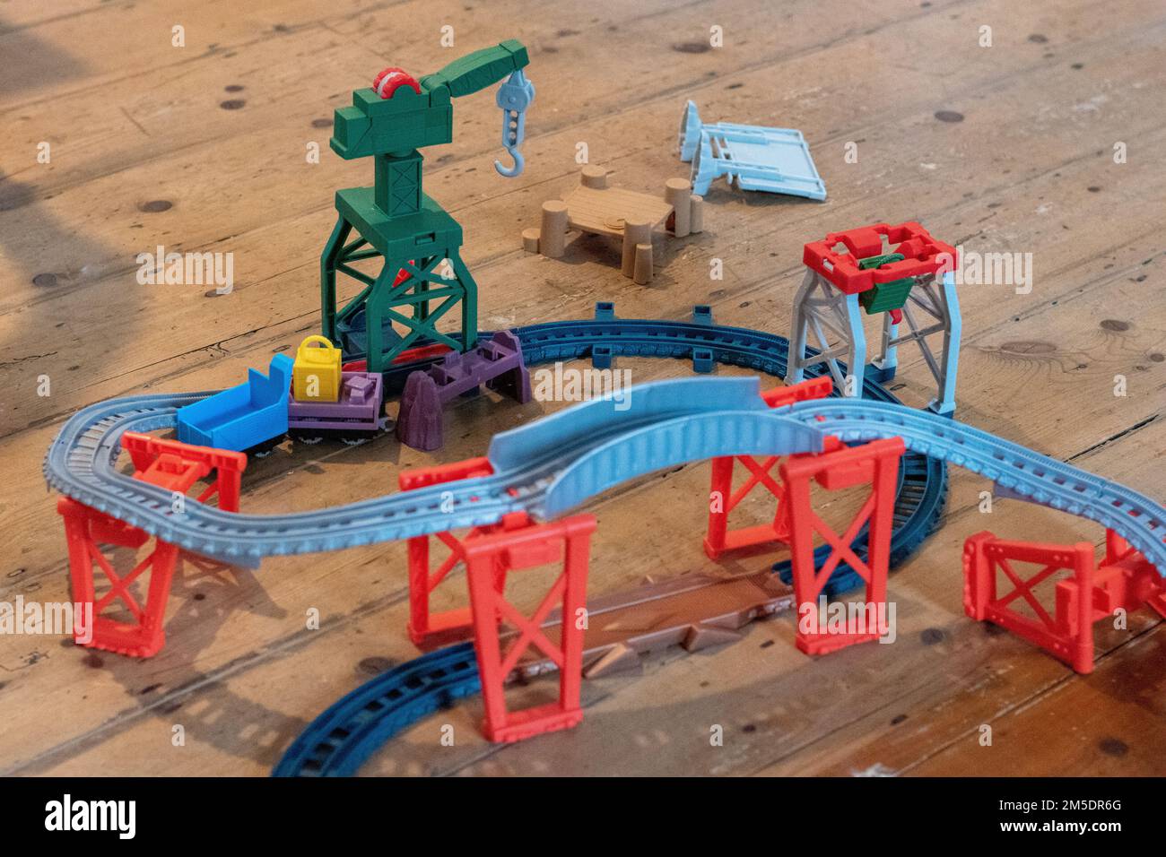 Thomas the Tank Engine plastic toy rail track train track with crane visible Stock Photo