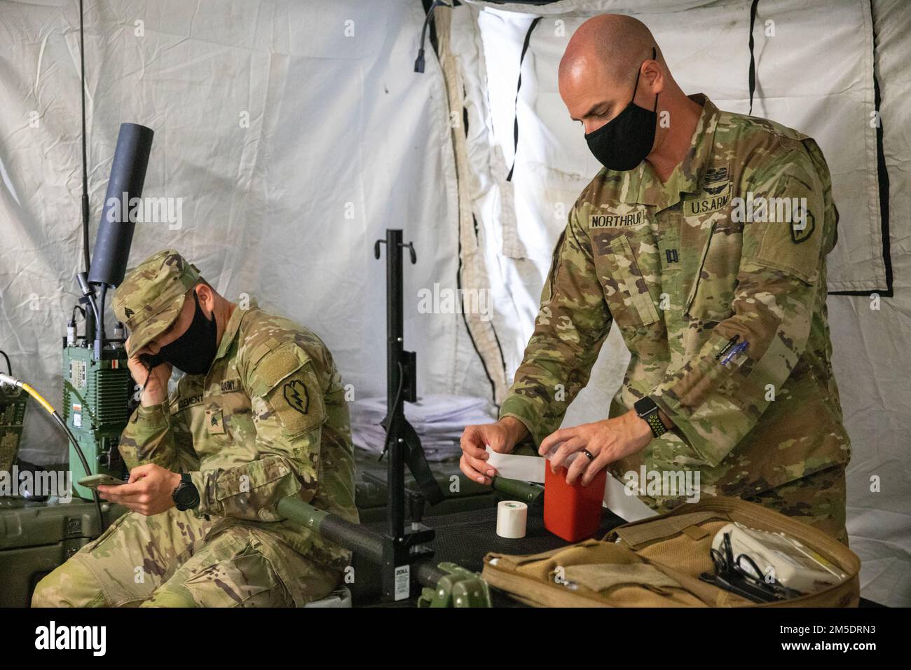 U.S. Army Sgt. Jarrod Clements, the Noncommissioned Officer-in-Charge of Fort Magsaysay's Aid Station with 2nd Battalion, 27th Infantry Regiment, 3rd Infantry Brigade Combat Team, 25th Infantry Division, and Capt. Nathaniel Northrup, Aeromedical Physician Assistant-Certified, with 325th General Support Aviation Battalion, 25th Combat Aviation Brigade, participate in a ground evacuation drill on Fort Magsaysay, Nueva Ecija, Philippines, March 5, 2022. Nearly 1,100 U.S. Army Pacific Soldiers will participate in Salaknib alongside their Philippine counterparts to improve interoperability and stre Stock Photo